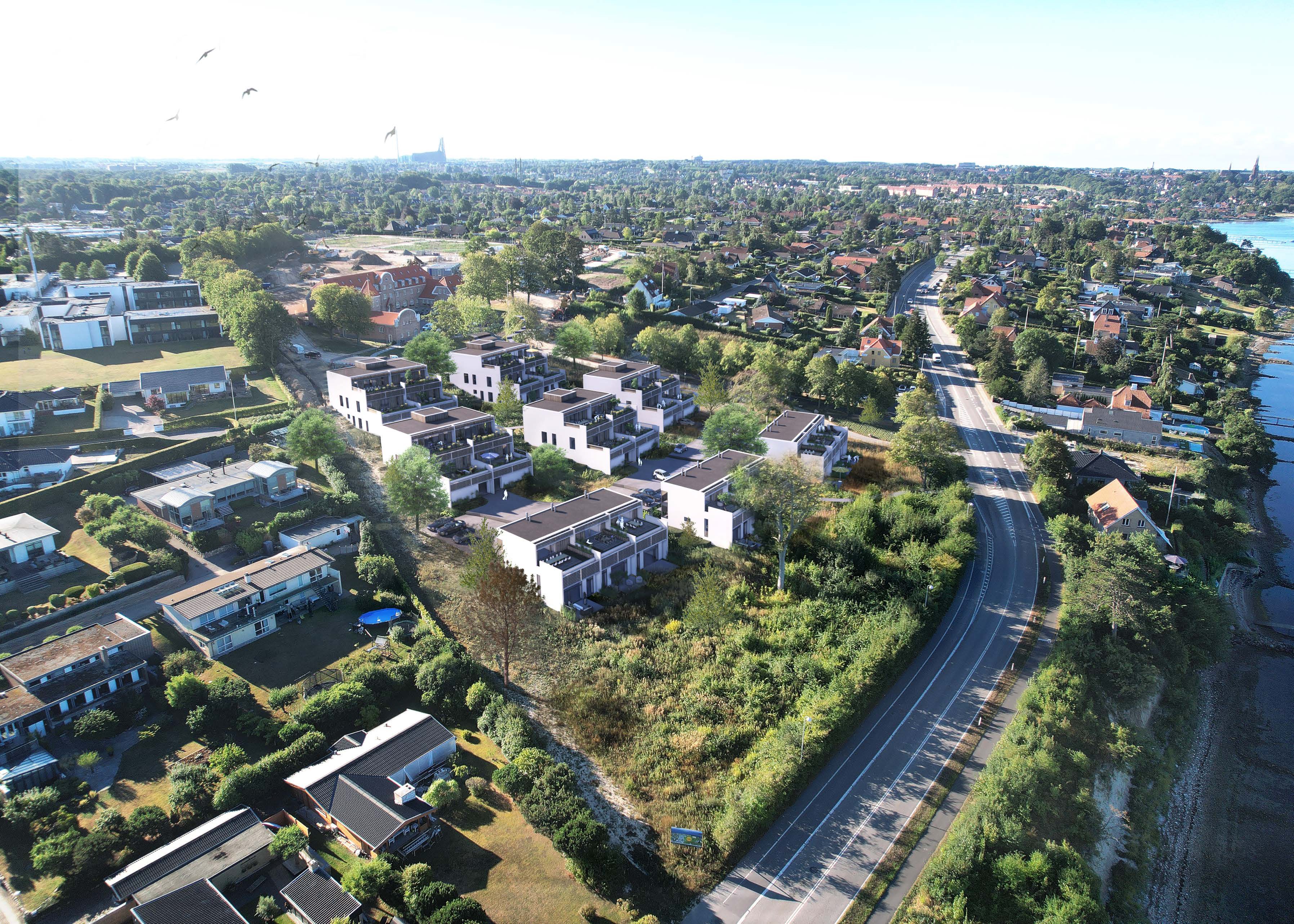 Moderne bybolig, kendetegnet ved reflekterende glas og et råt betondesign.