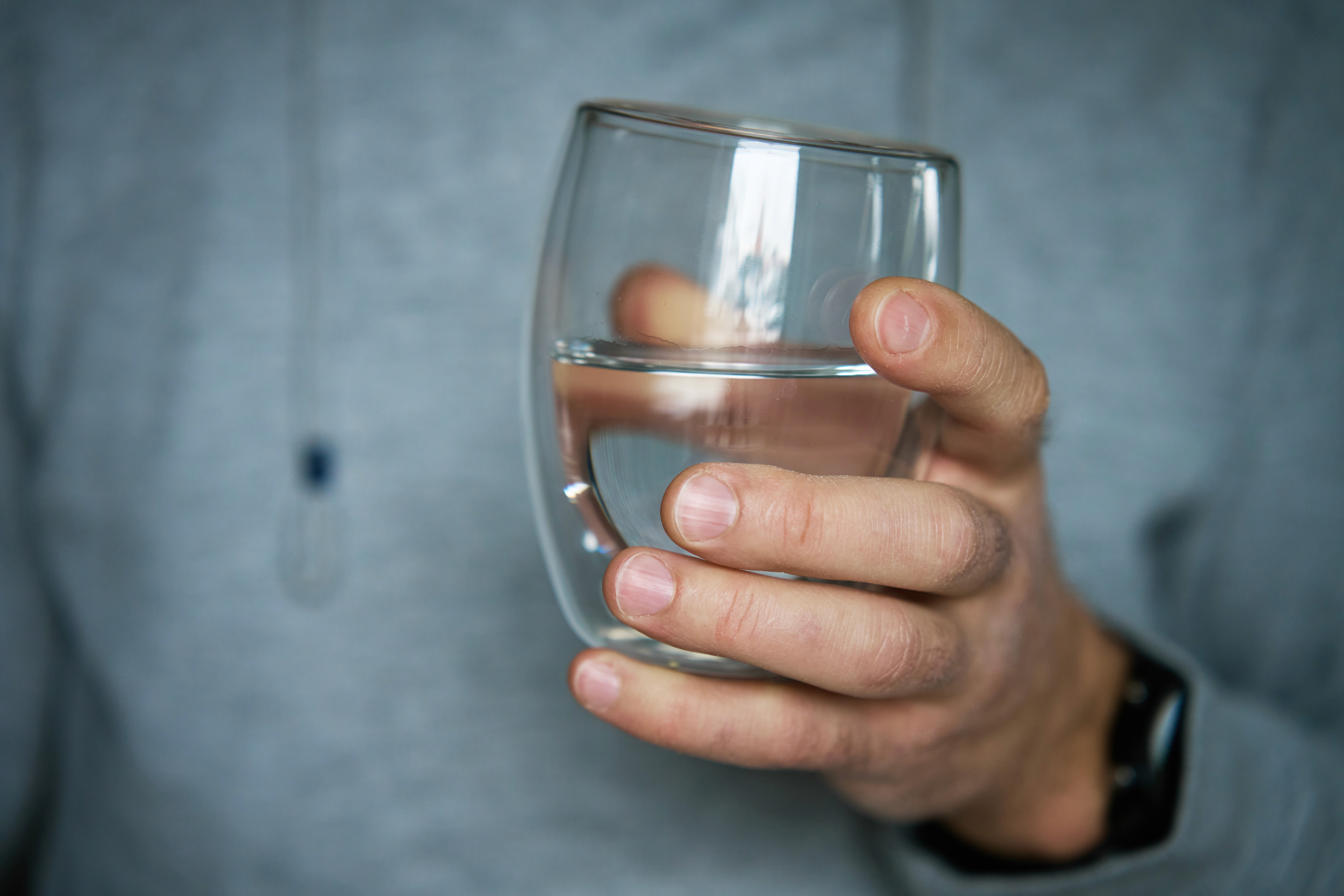 man-holds-glass-of-clean-water