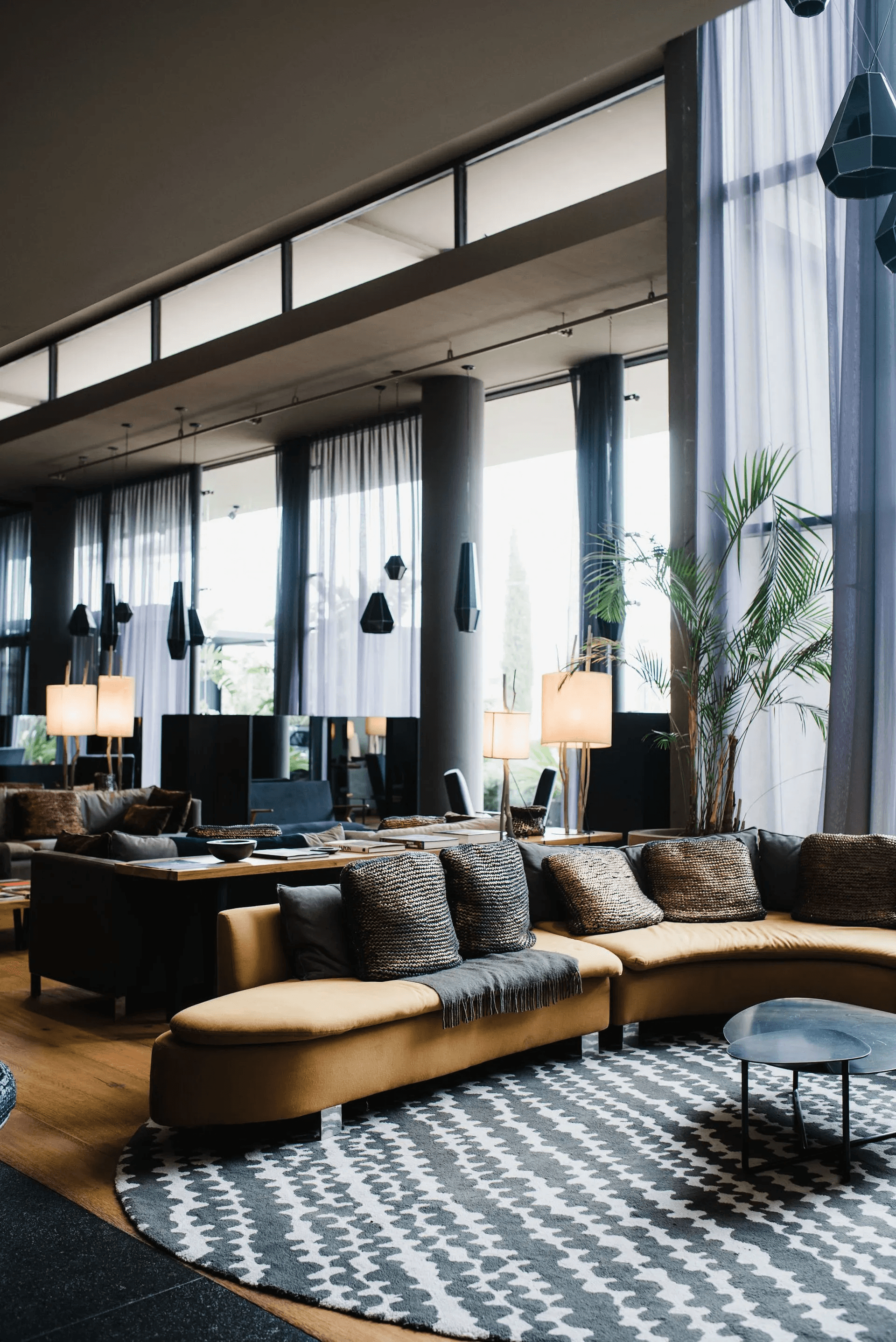 a bed with white sheets and pillows in a room