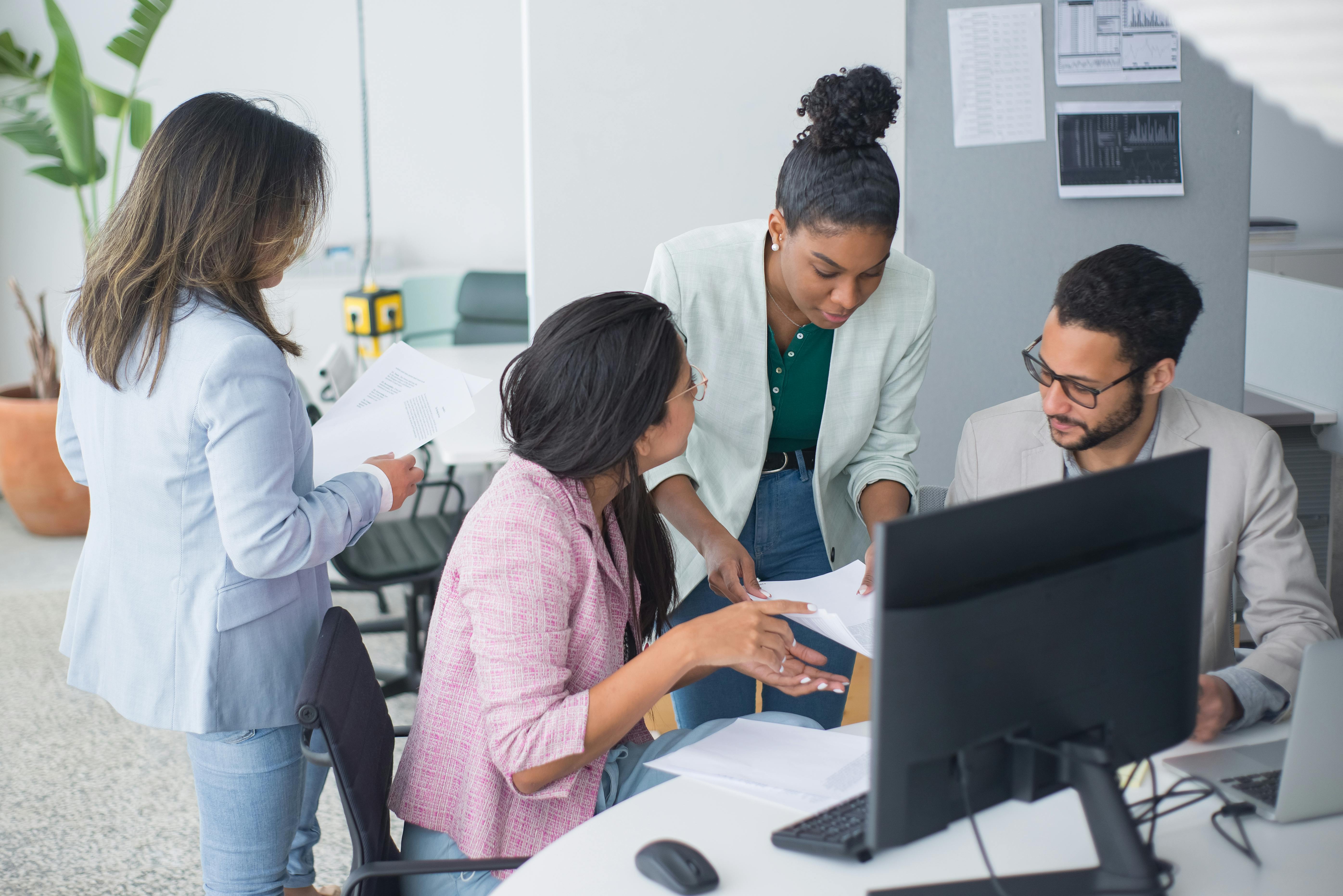 People in the office having a discussion about sending cold emails