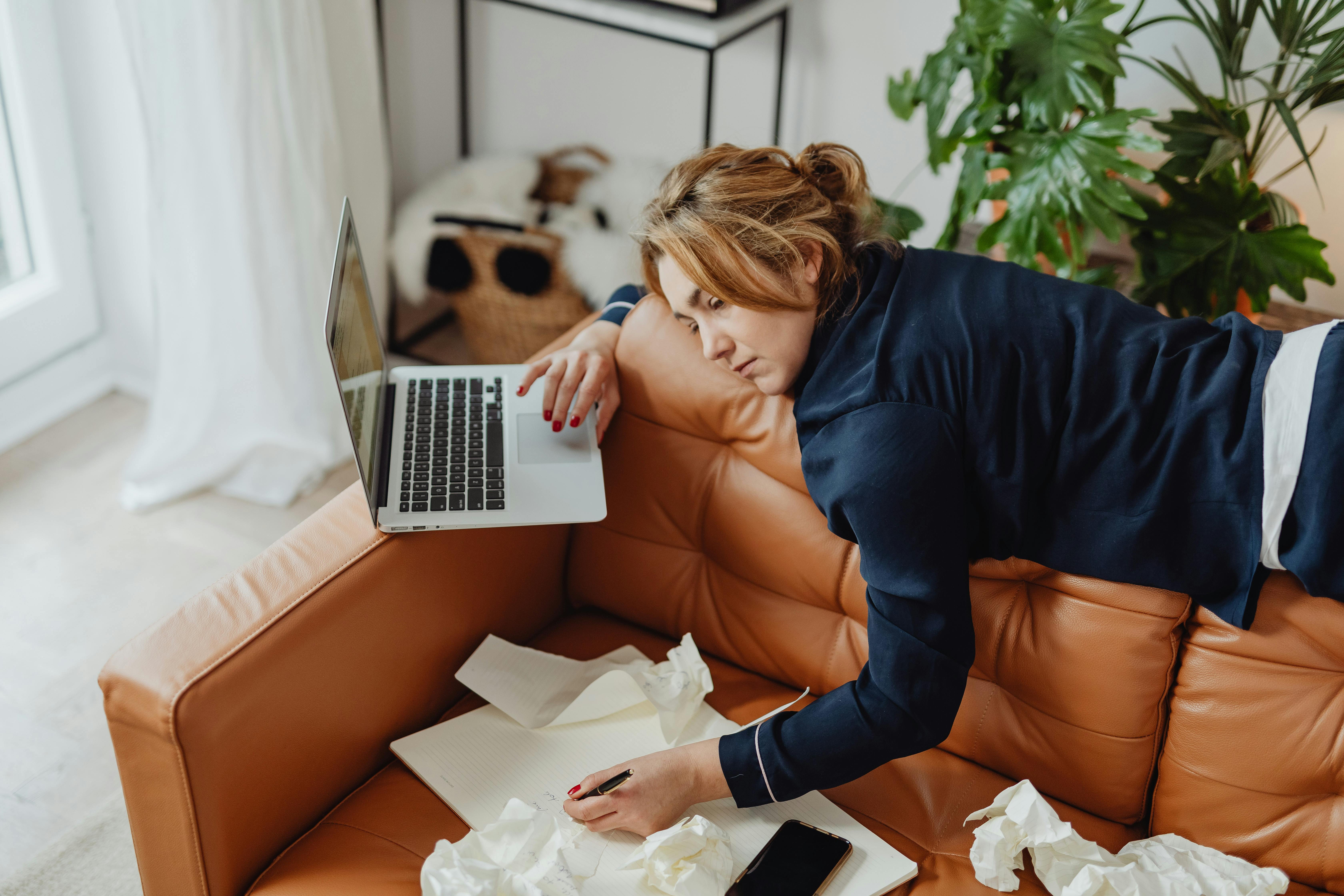 Woman sitting on couch unable to relax, looking restless and distracted