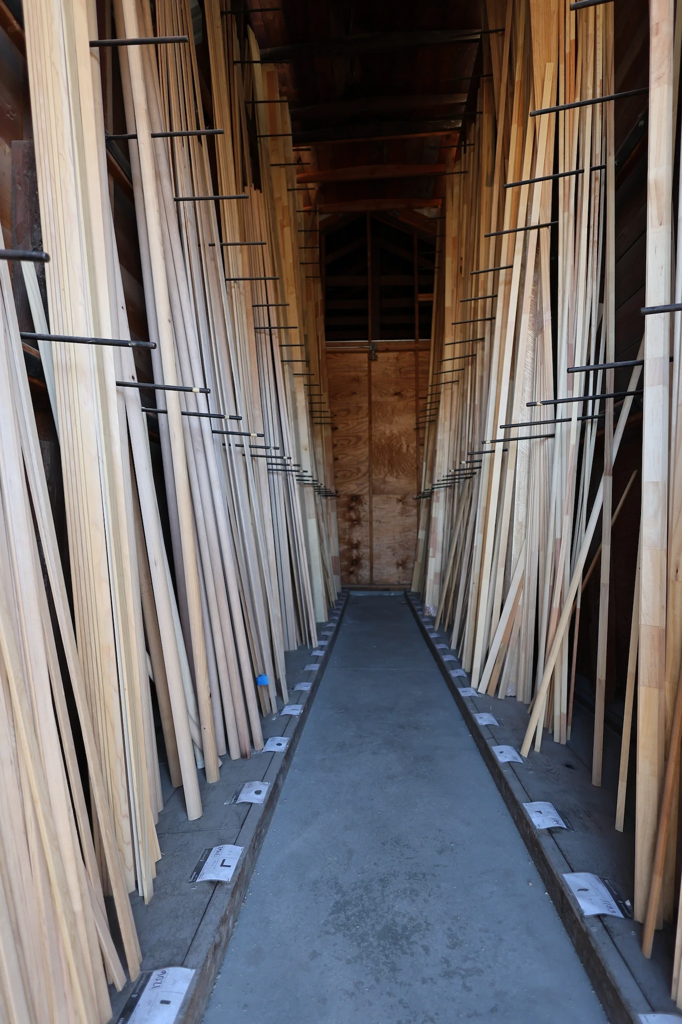 Vertical racks of trim and millwork profiles inside Capital Lumber