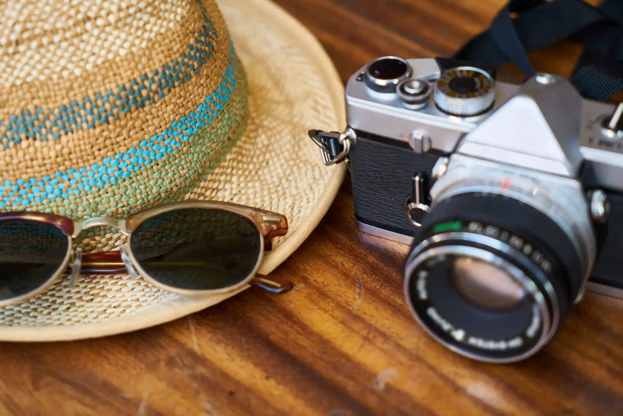 Straw hat, sunglasses, vintage camera for travel