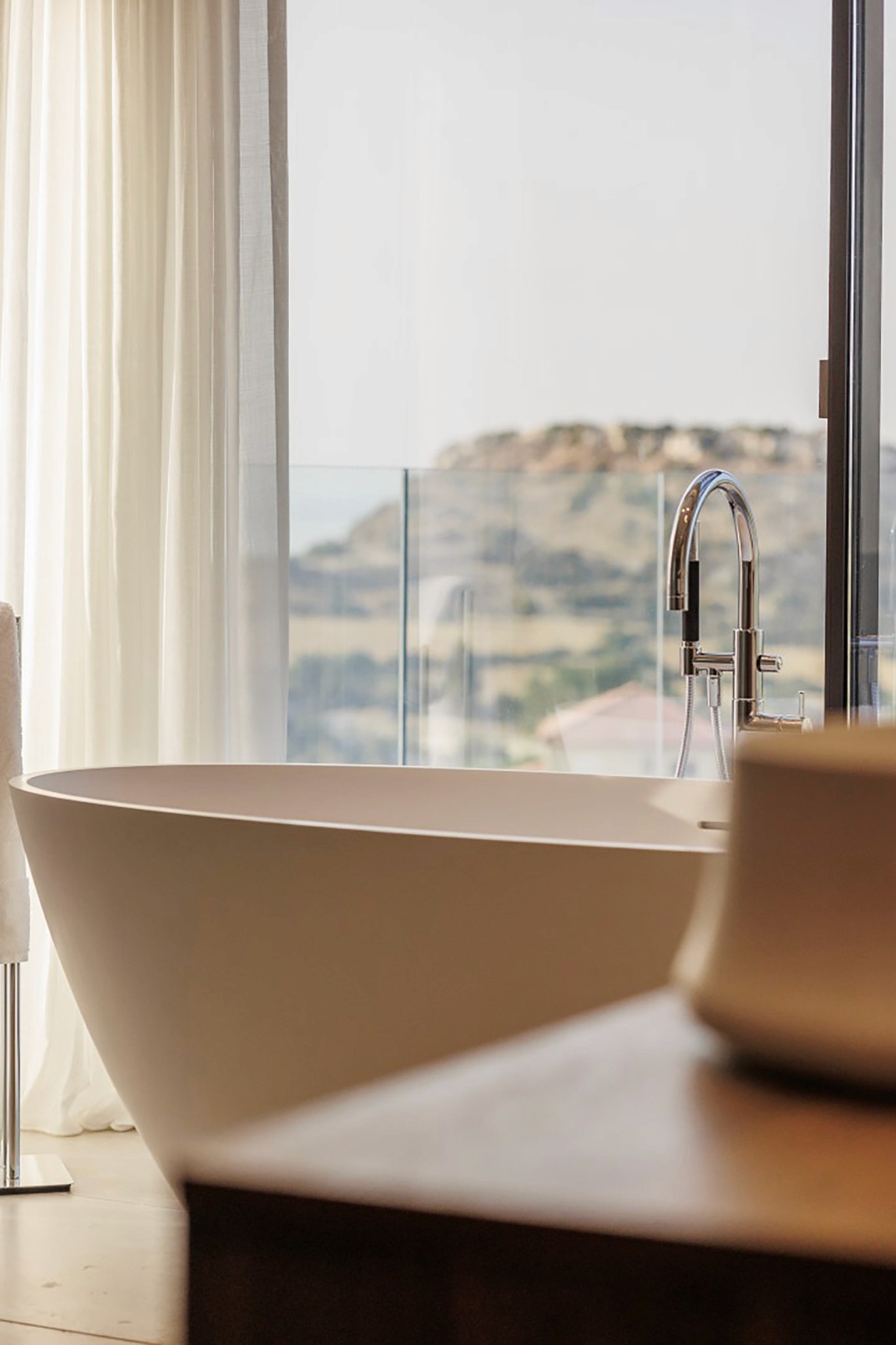 Villa Trio bathroom detail with freestanding bathtub by a floor-to-ceiling window