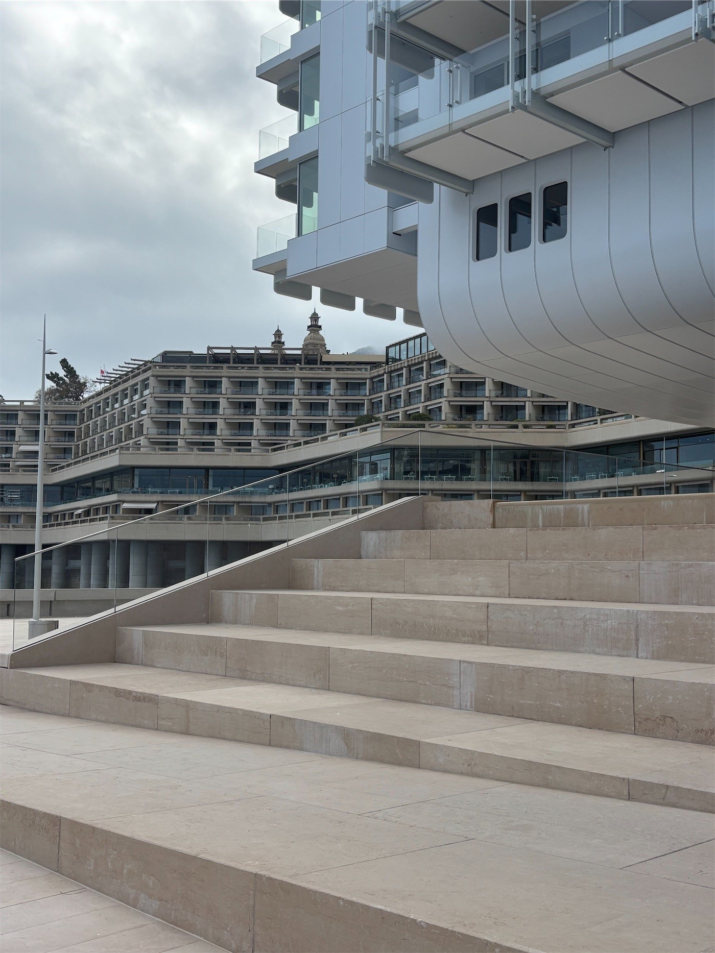Stone steps beneath the curved underside of a white building