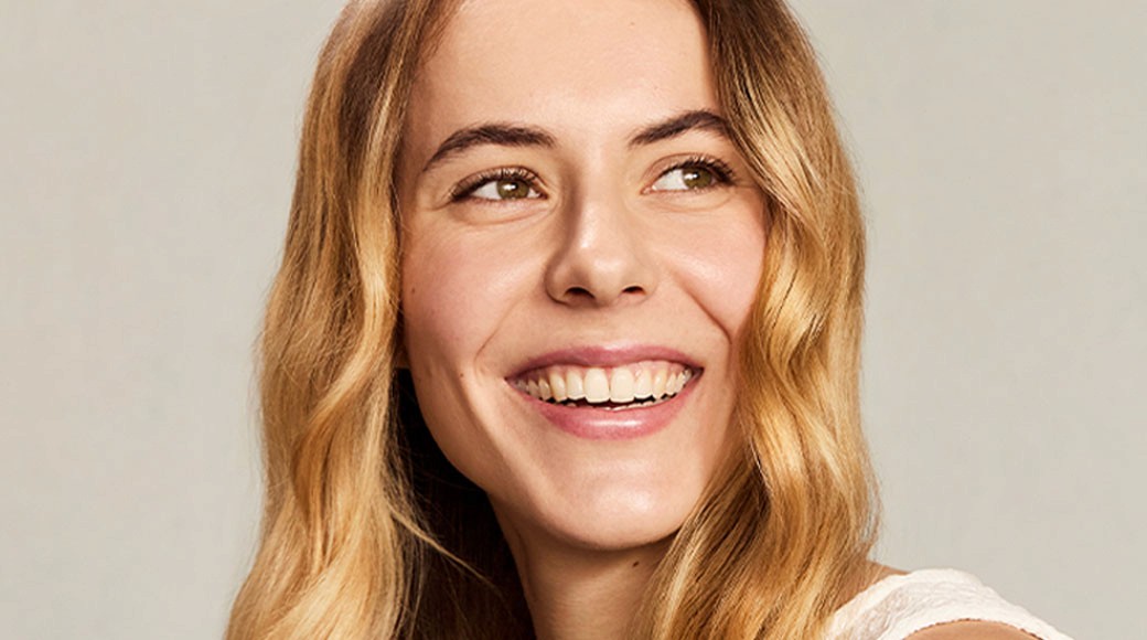 Woman with blond curly hair smiling