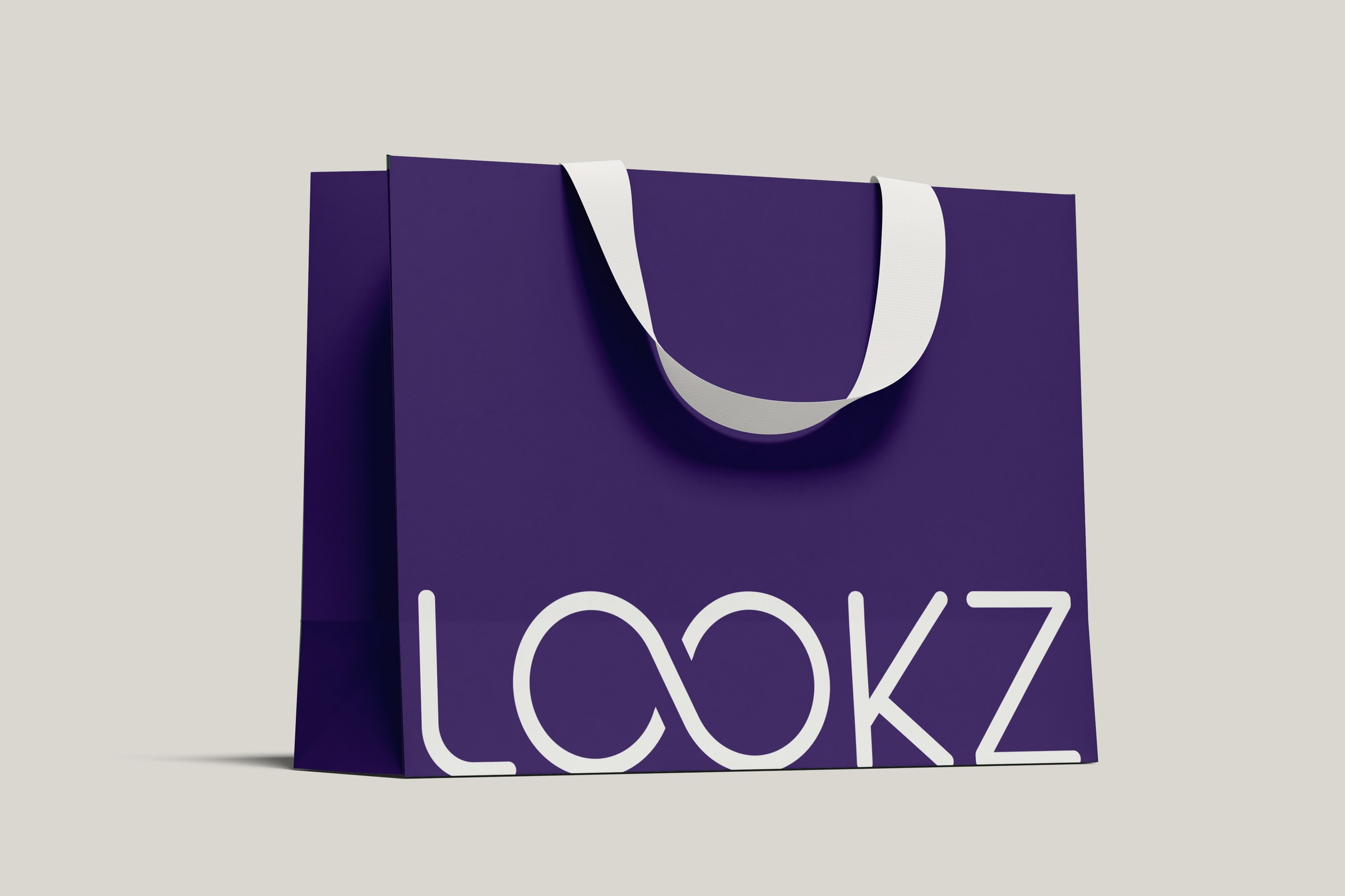 LOOKZ logo on a single purple paper shopping bag