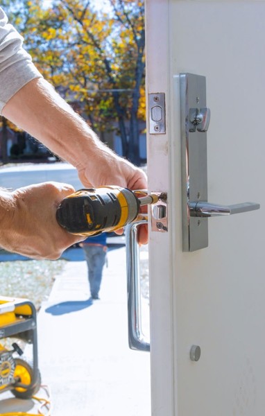 locksmith installing a door lock