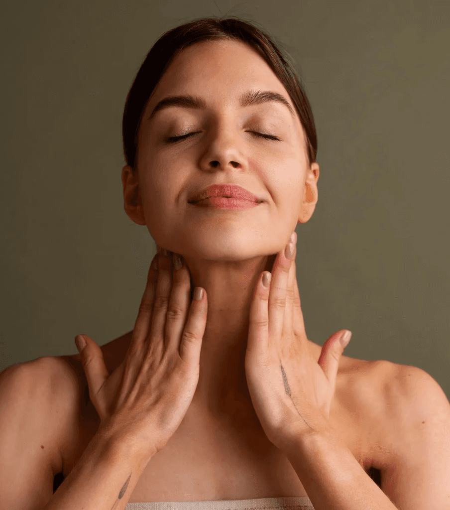 Calm woman drinking from a glass, symbolizing inner balance, rejuvenation, and cellular health supported by exosome and peptide therapy.