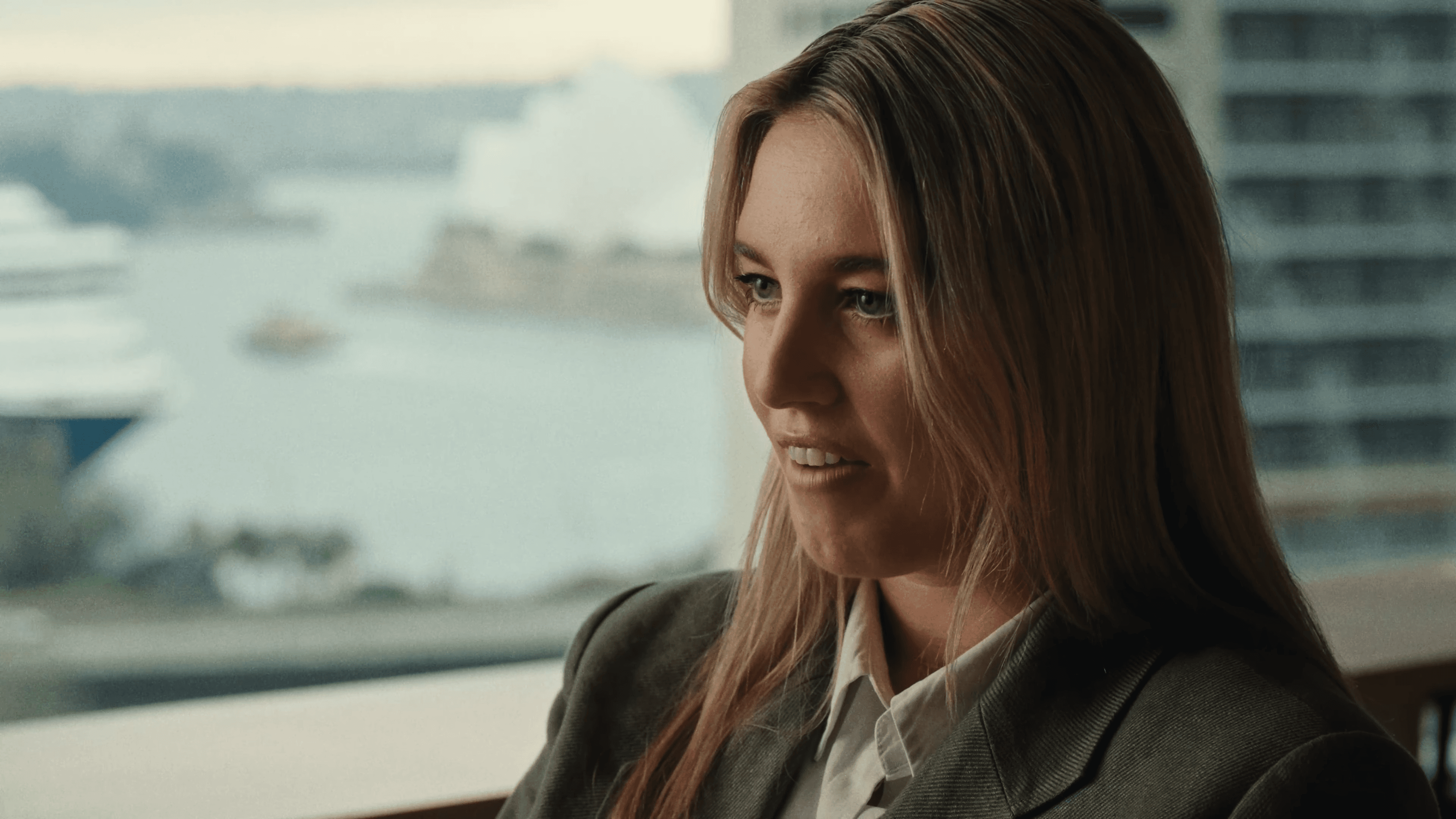 Wotton Kearney lawyer in the firm's Sydney office, harbour visible through the window