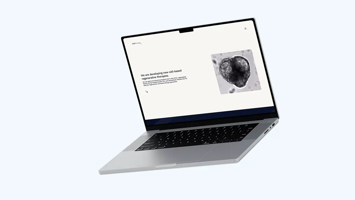 Ein Bild von einem schwebenden Laptop mit der Website von celltherapy vor einem hellblauen Hintergrund.
