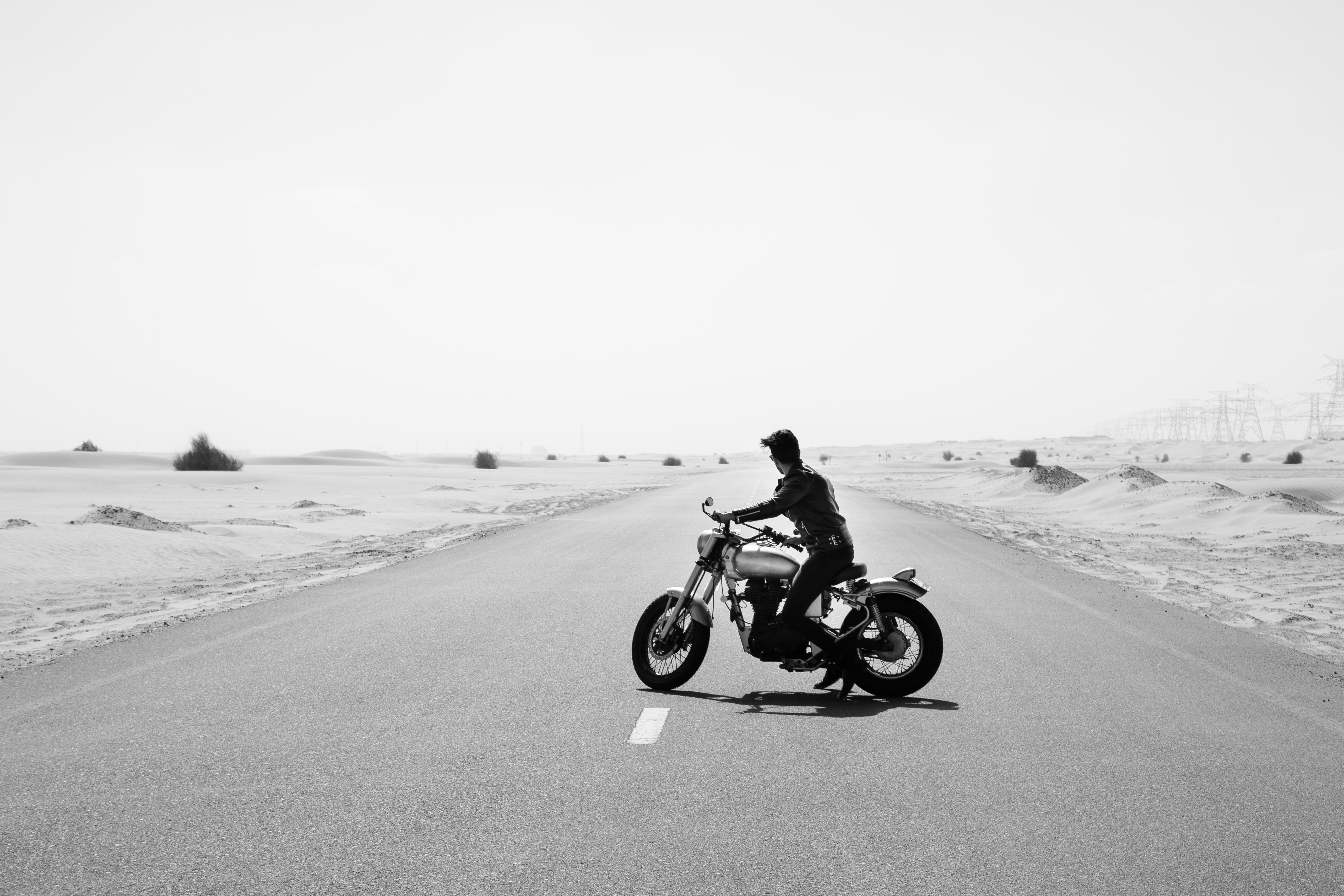 Black and white of a guy on a bike in the UAE desert | Bonanza Satrangi’s: Perfume TV Commercial Production | Relity Group