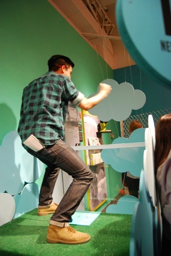 a man being happy for hitting the hole on a mini-golf course
