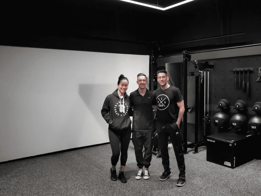 The Custom Home Gym Builds team in a completed garage custom gym.