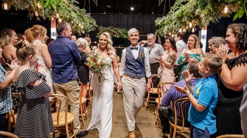 Bride & Bride walking down the aisle after being married