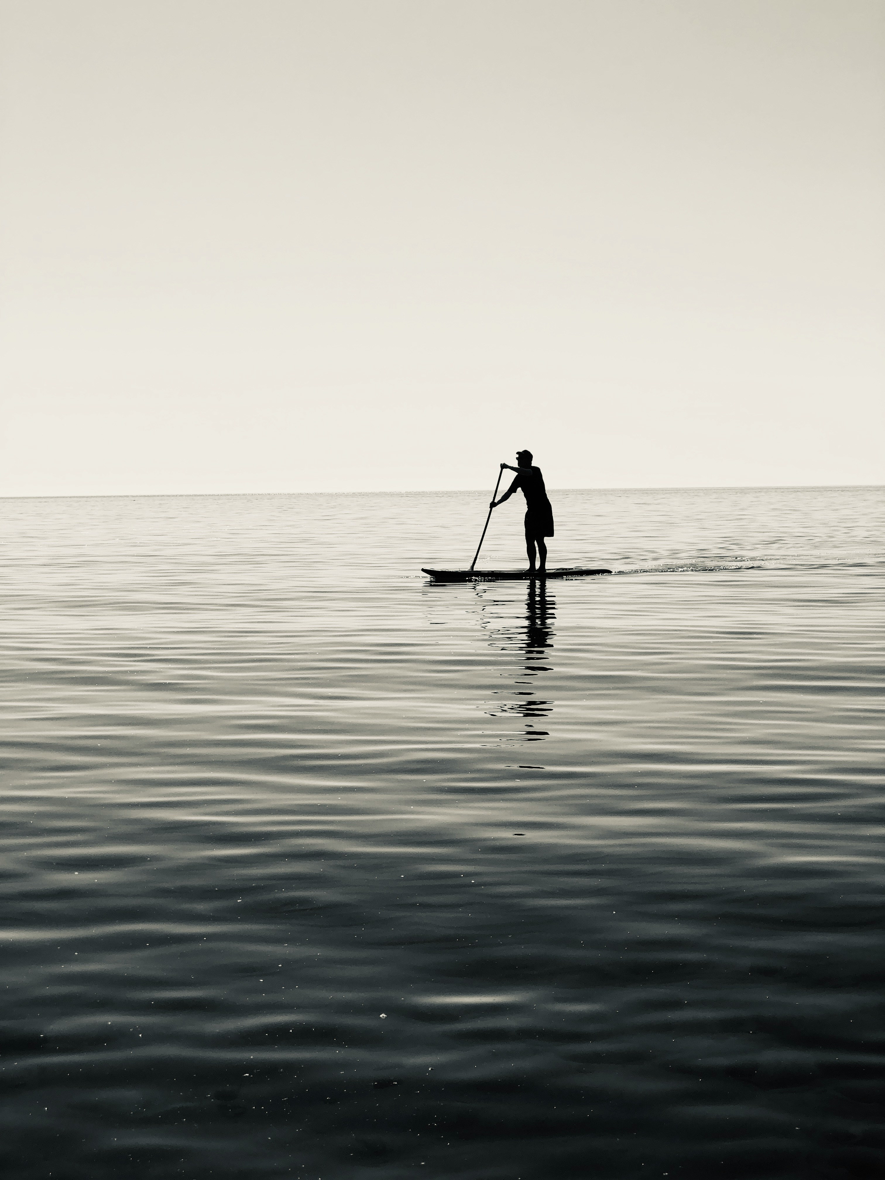 silhouette of person riding on boat on sea during daytime
