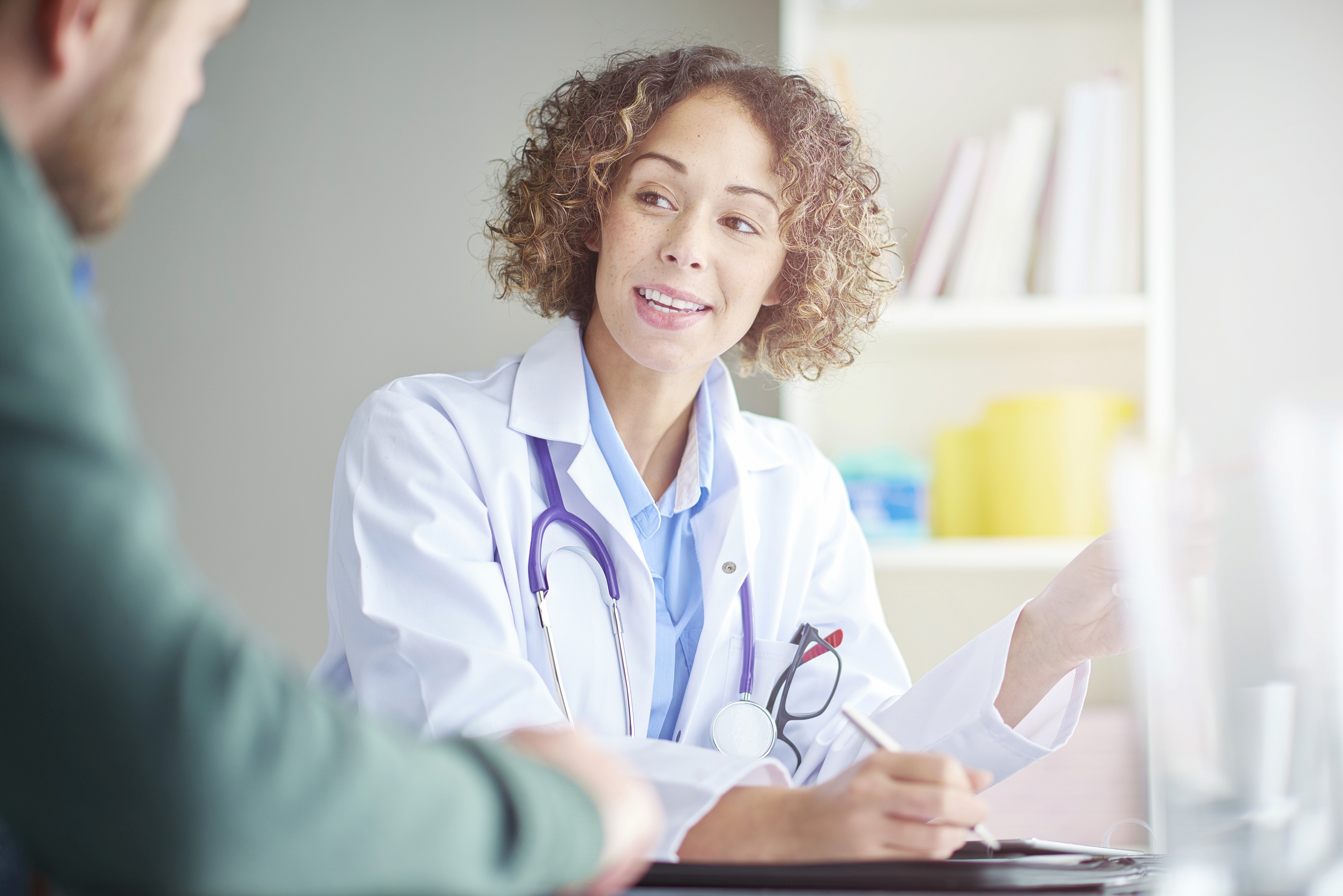 Medical leader in white coat in a meeting