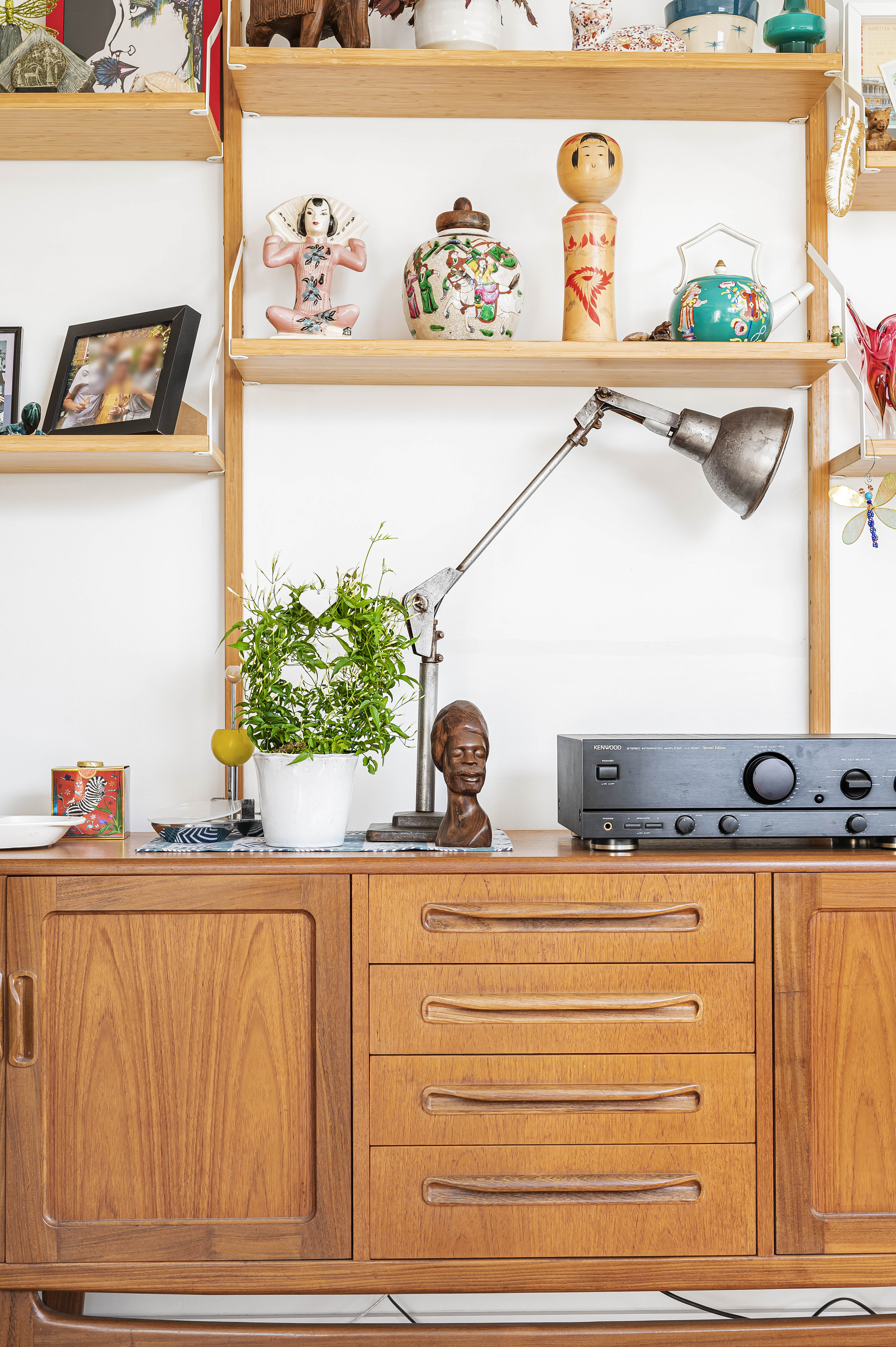 Two women in elegant attire lean towards each other, sharing a tender moment in a beautifully decorated space.