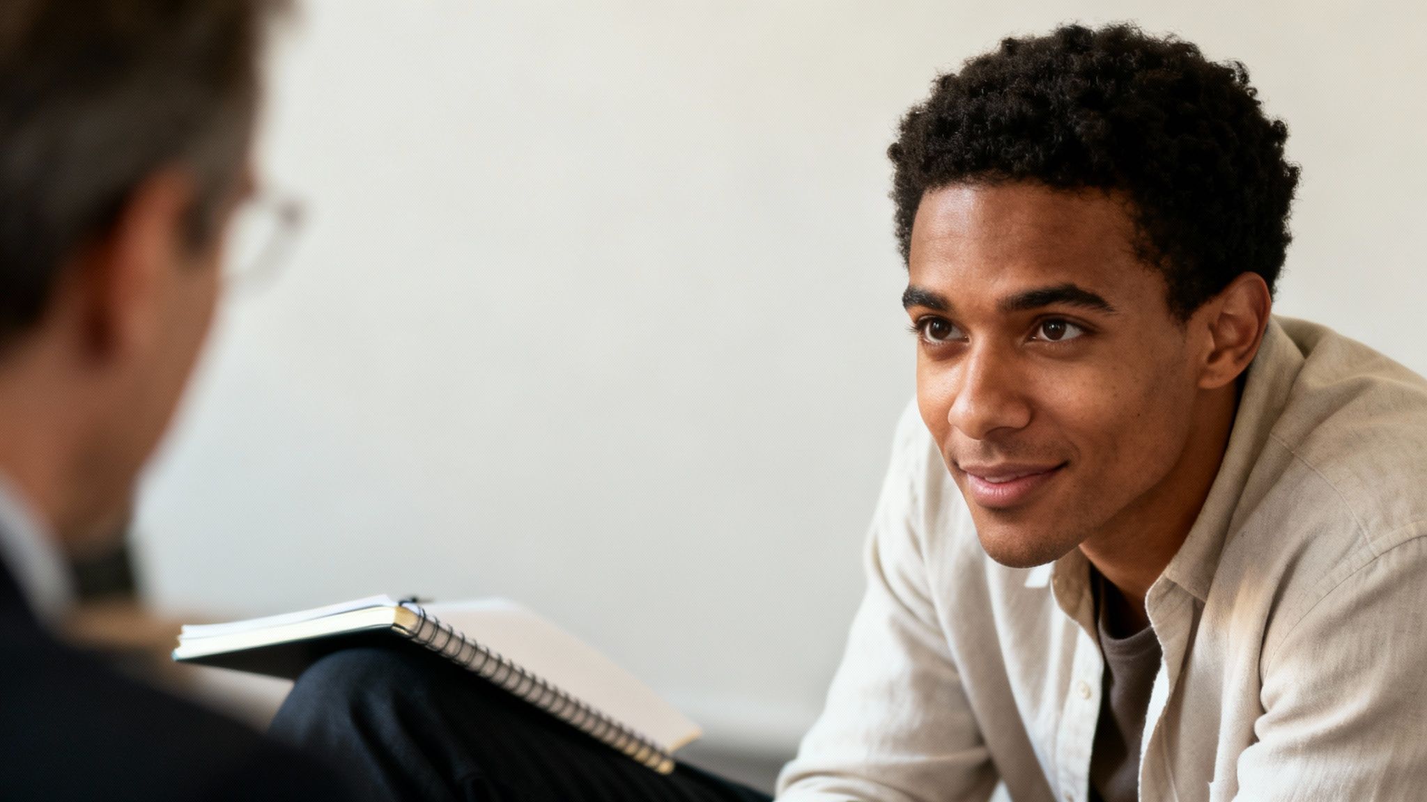 Speak4Me – Two people sitting across from each other at a table, deeply engaged in a conversation, illustrating active listening.