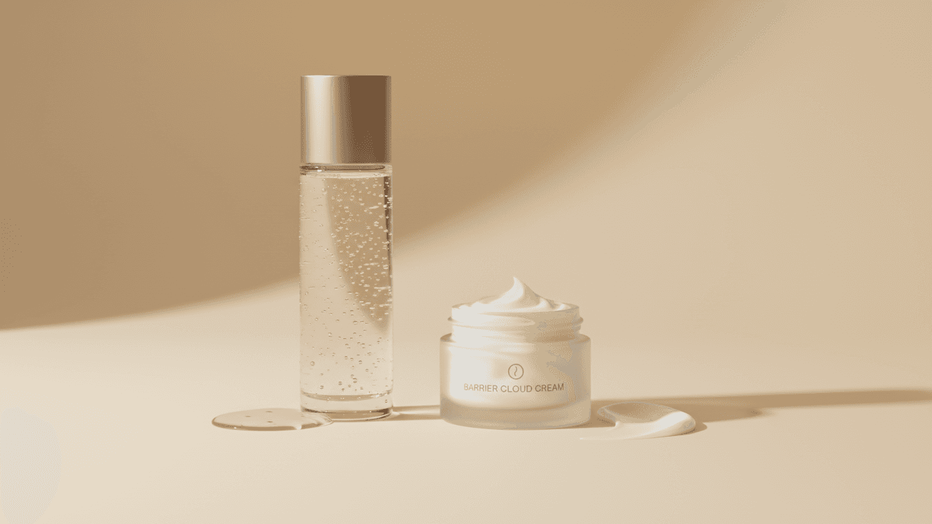 On the left, a tall, slim glass bottle of clear hydrating essence with tiny water droplets on the outside, next to a glossy splash of liquid on the surface. On the right, a low round jar of rich cream with a soft swirl texture, next to a small smear of velvety cream.