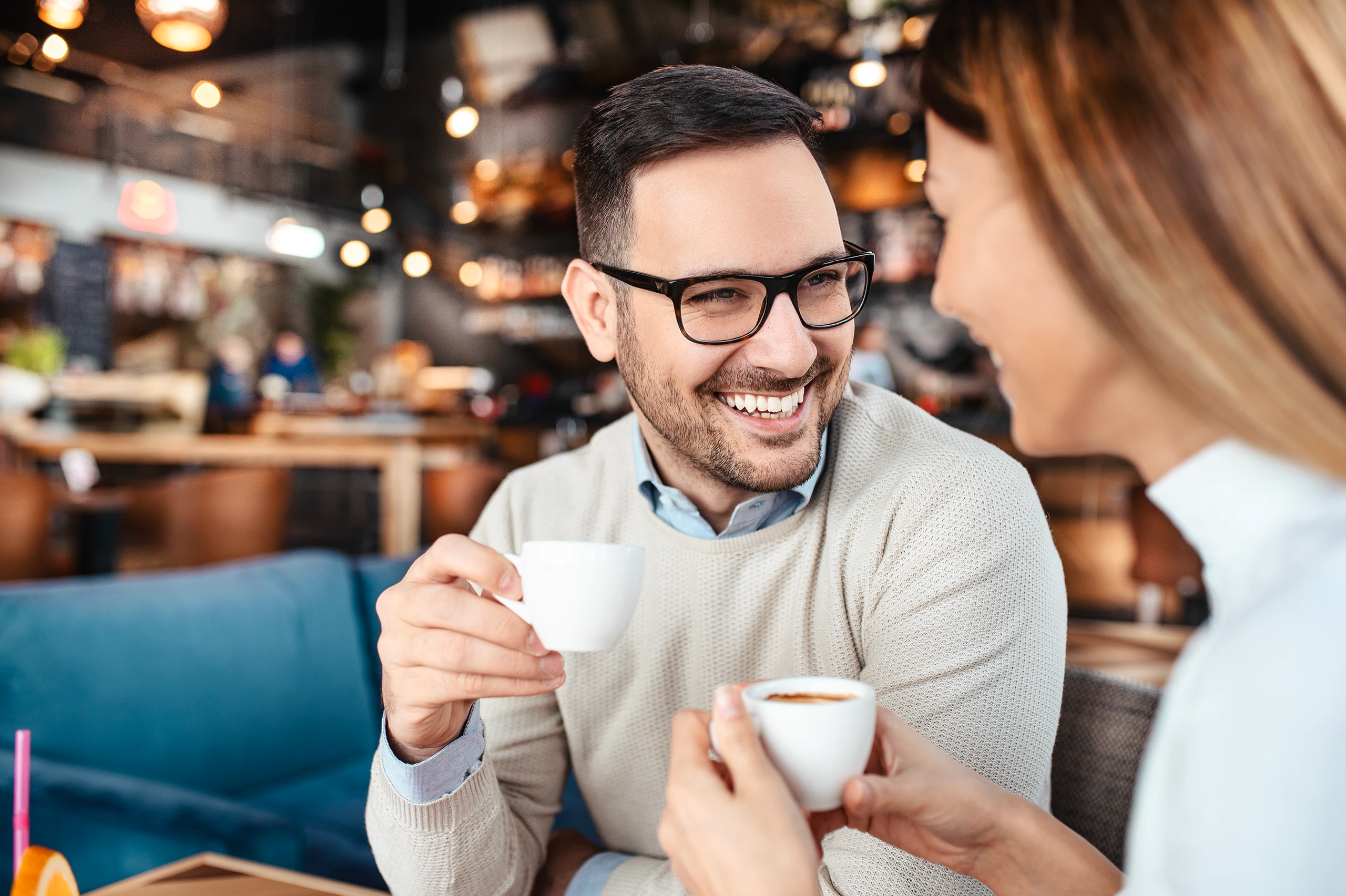 Couple enjoying coffee and conversation in a cozy cafe