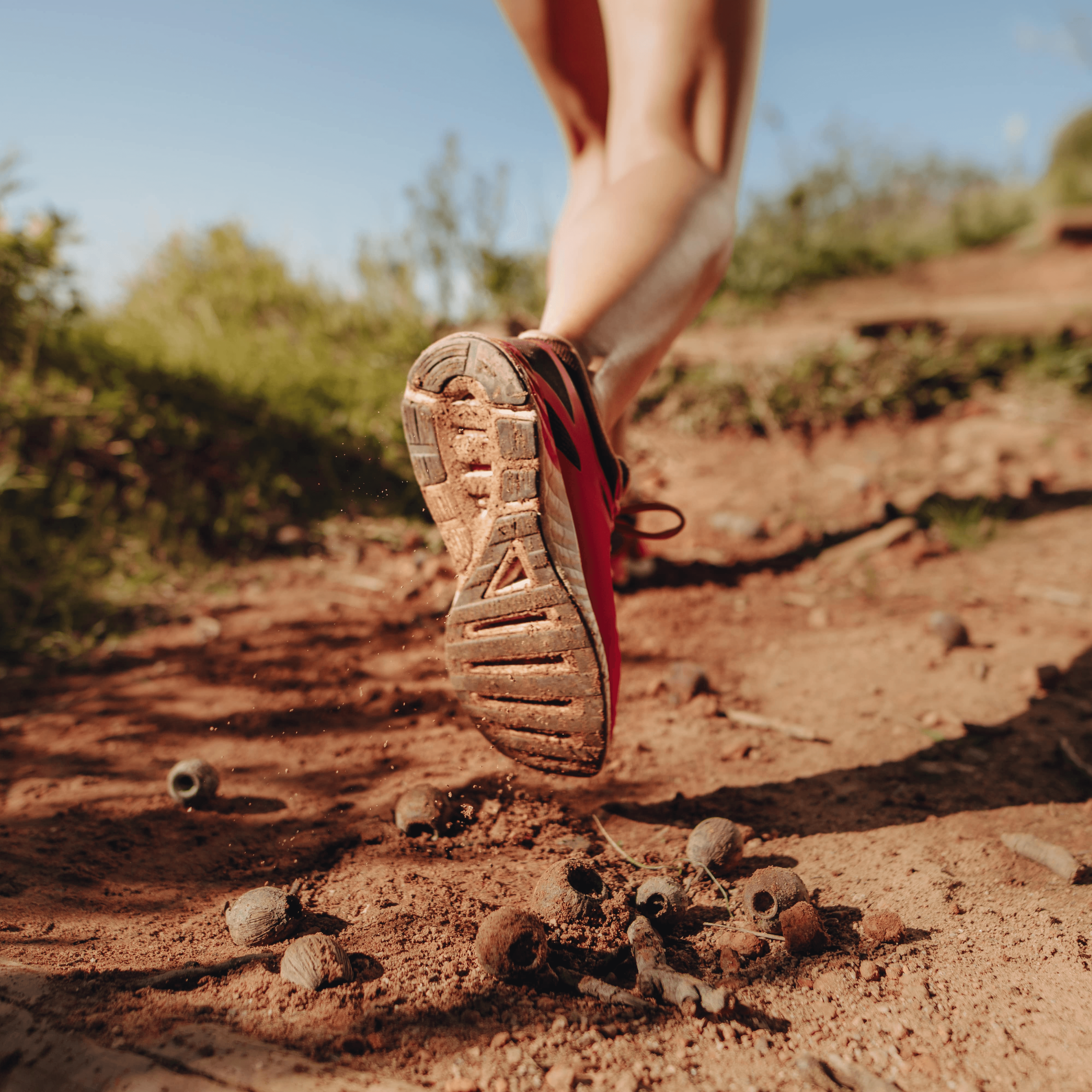 an athlete walking on a mud trail path