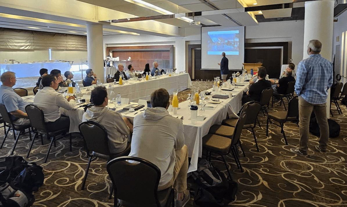Two businessmen shaking hands outside an office building.