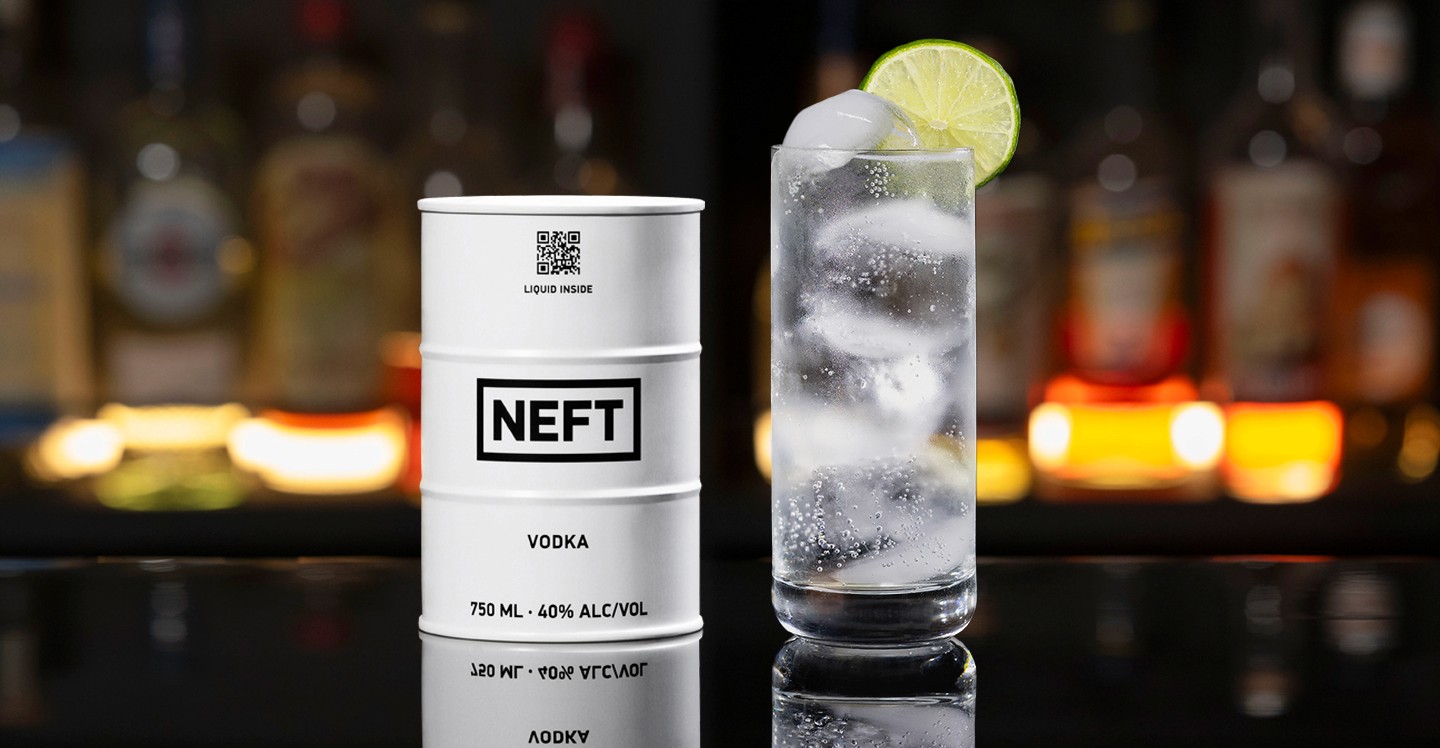 A NEFT Barrel and a glass of Vodka Soda on a bar counter.