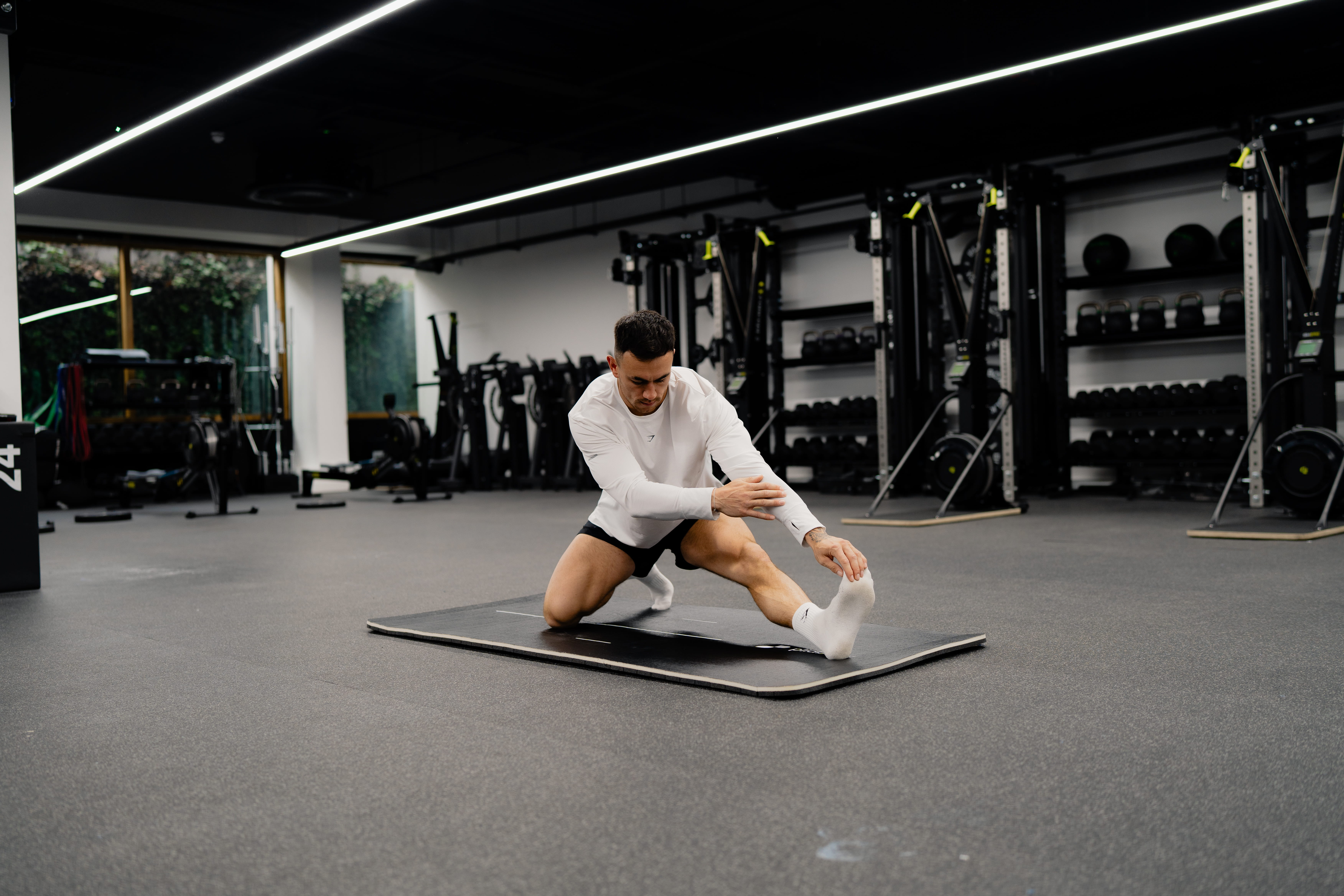 man stretching - Strength Training Workout for Runners