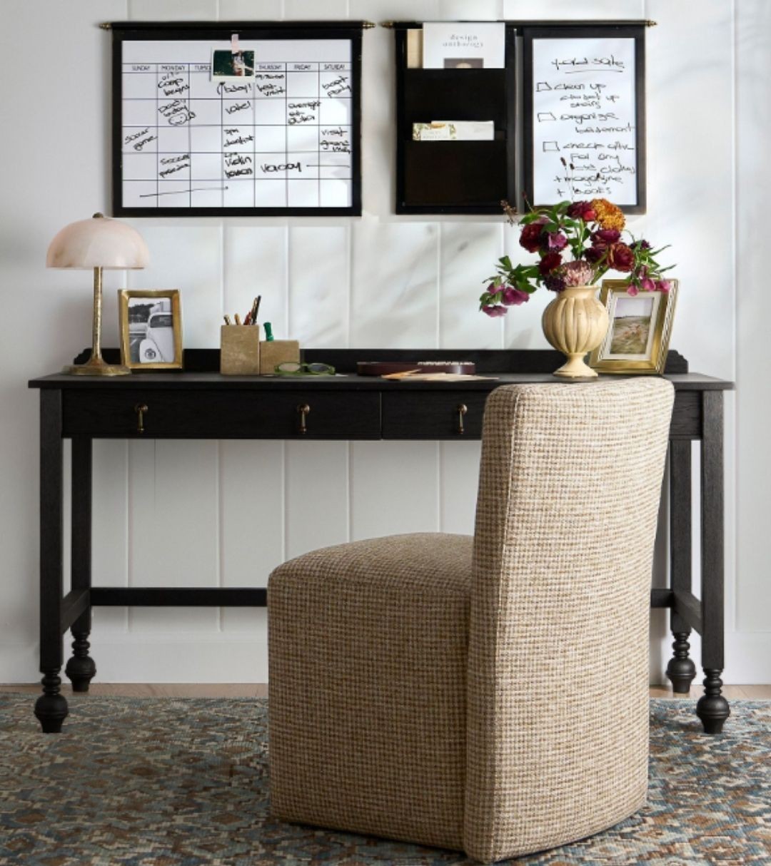 Office with black desk, beige chair and decor
