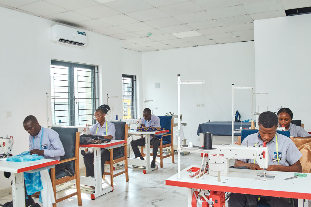 white and teal steam clothes iron plugged on ironing board