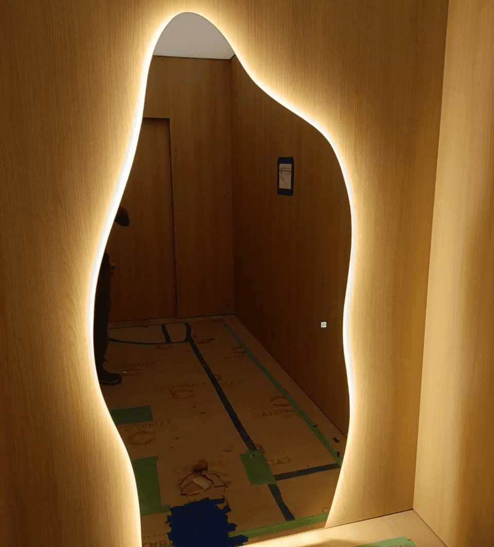 man wearing gray polo shirt beside dry-erase board