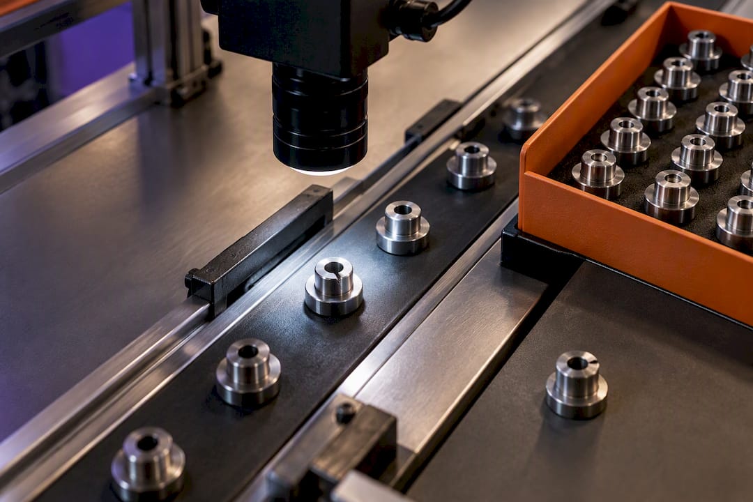 Camera inspecting manufactured metal parts