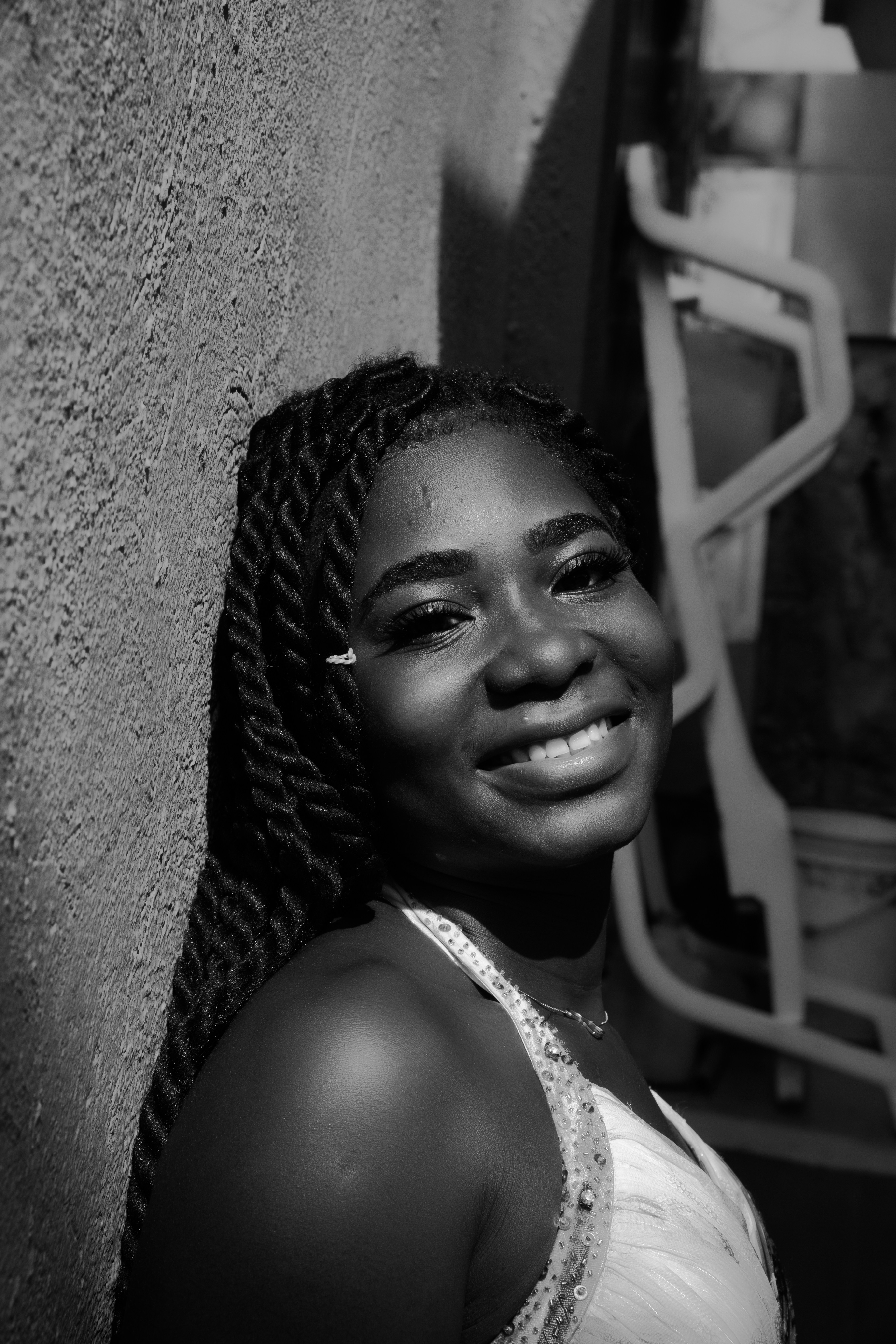 woman in white tank top smiling