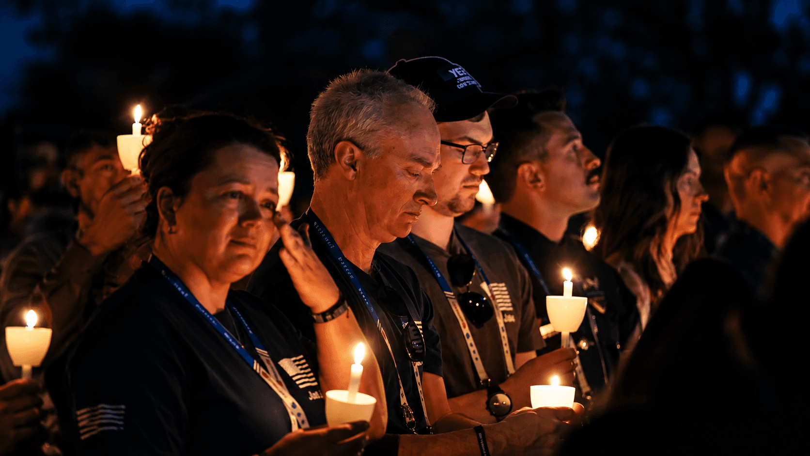 people holding candles candlelight vigil