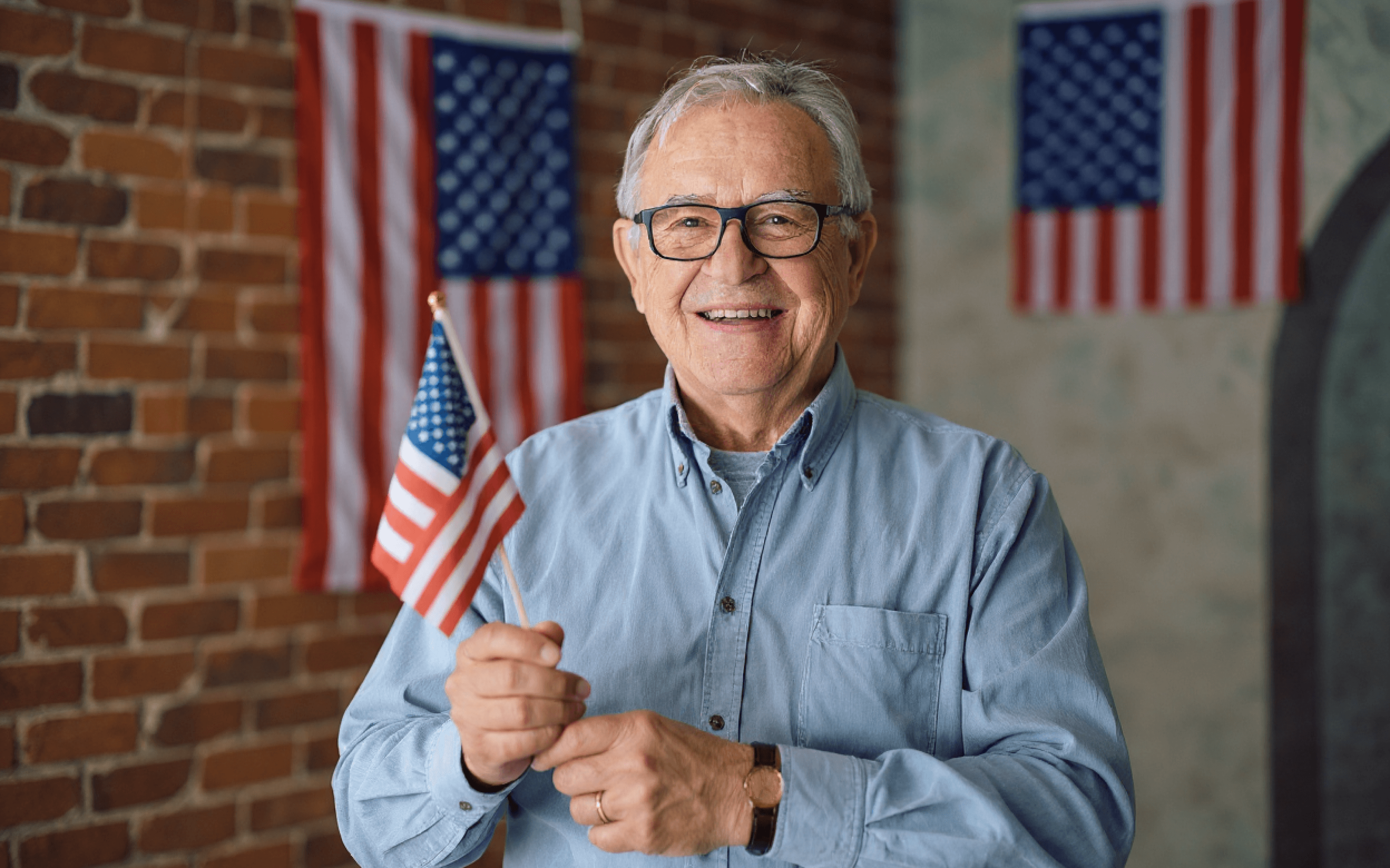 an old man holding US Flag
