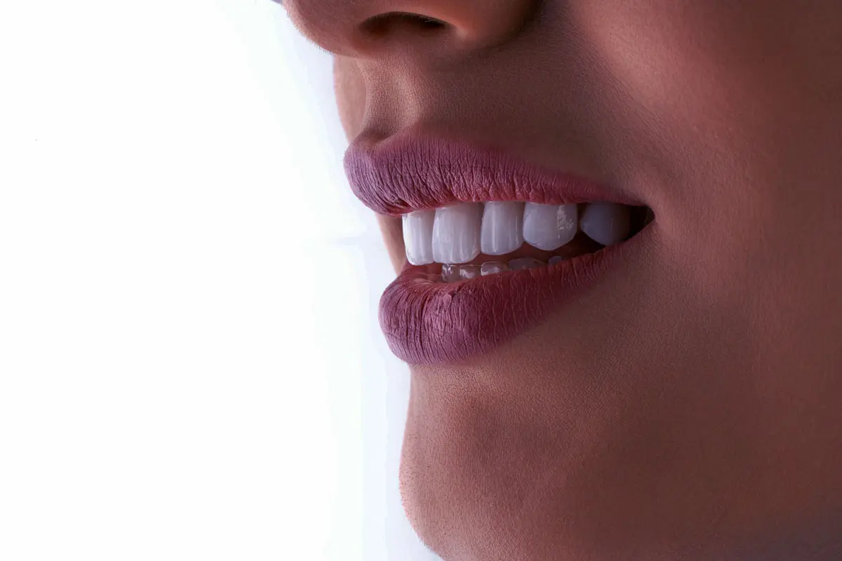 Close up of a female smile, side view.