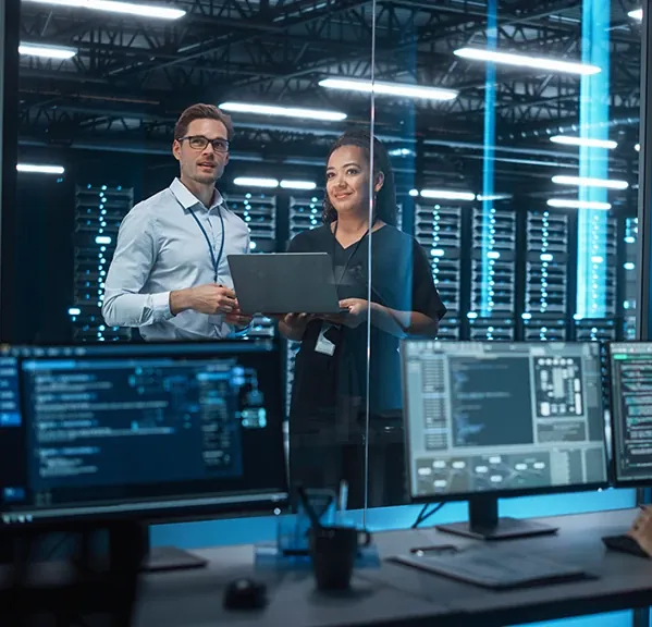 People working in a server room.