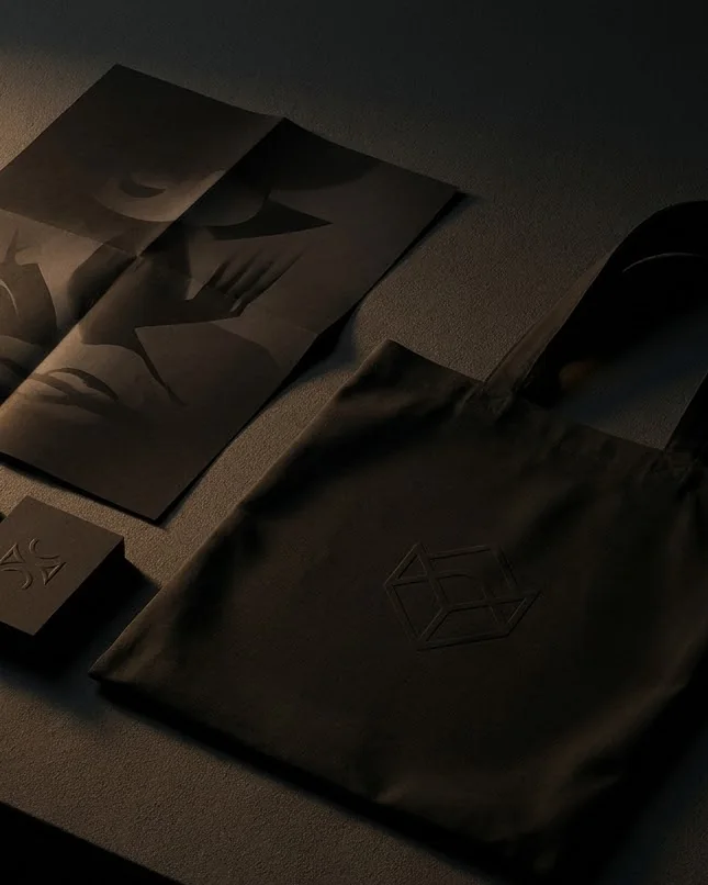 A black canvas tote bag on a dark surface