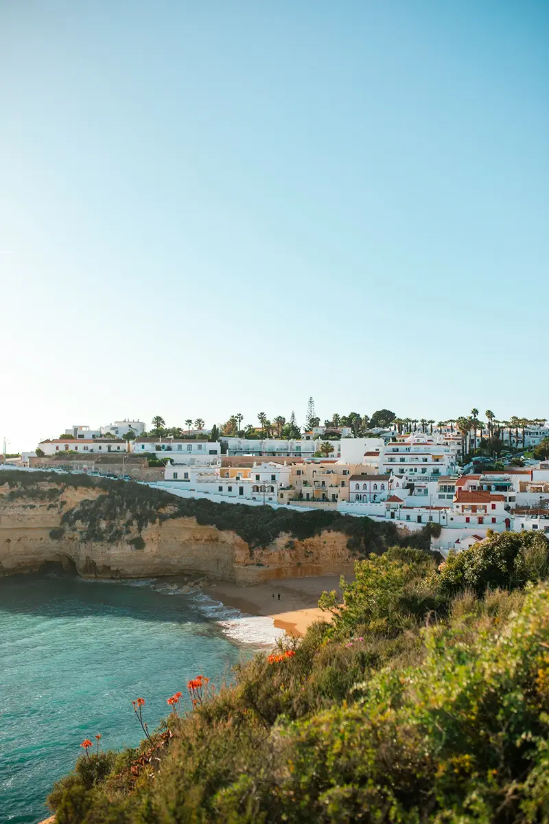 Coastal view near Faro with blue ocean and white buildings.