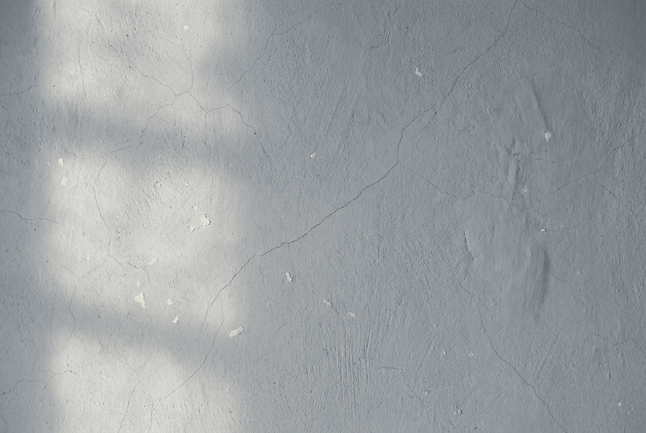 Fresco detail of pale plaster with a hairline crack under raking light