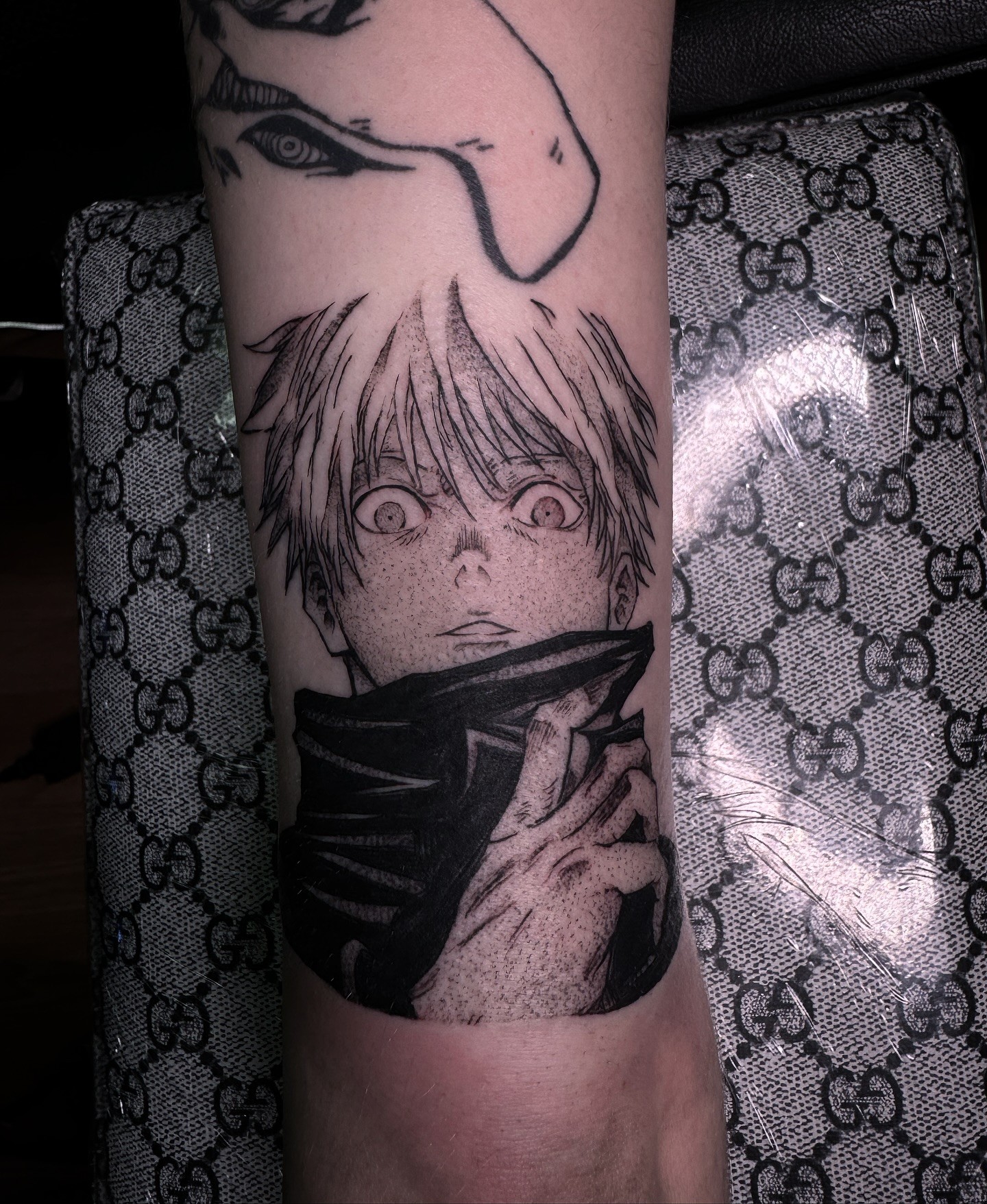 A forearm tattoo of Nezuko Kamado from Demon Slayer, depicted in a stylized anime art style. She is holding a sword.