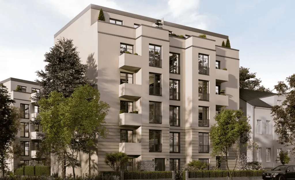 Modern apartment building with trees and a car.