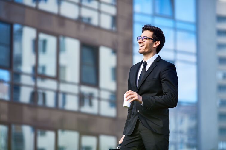 a happy man holding coffee