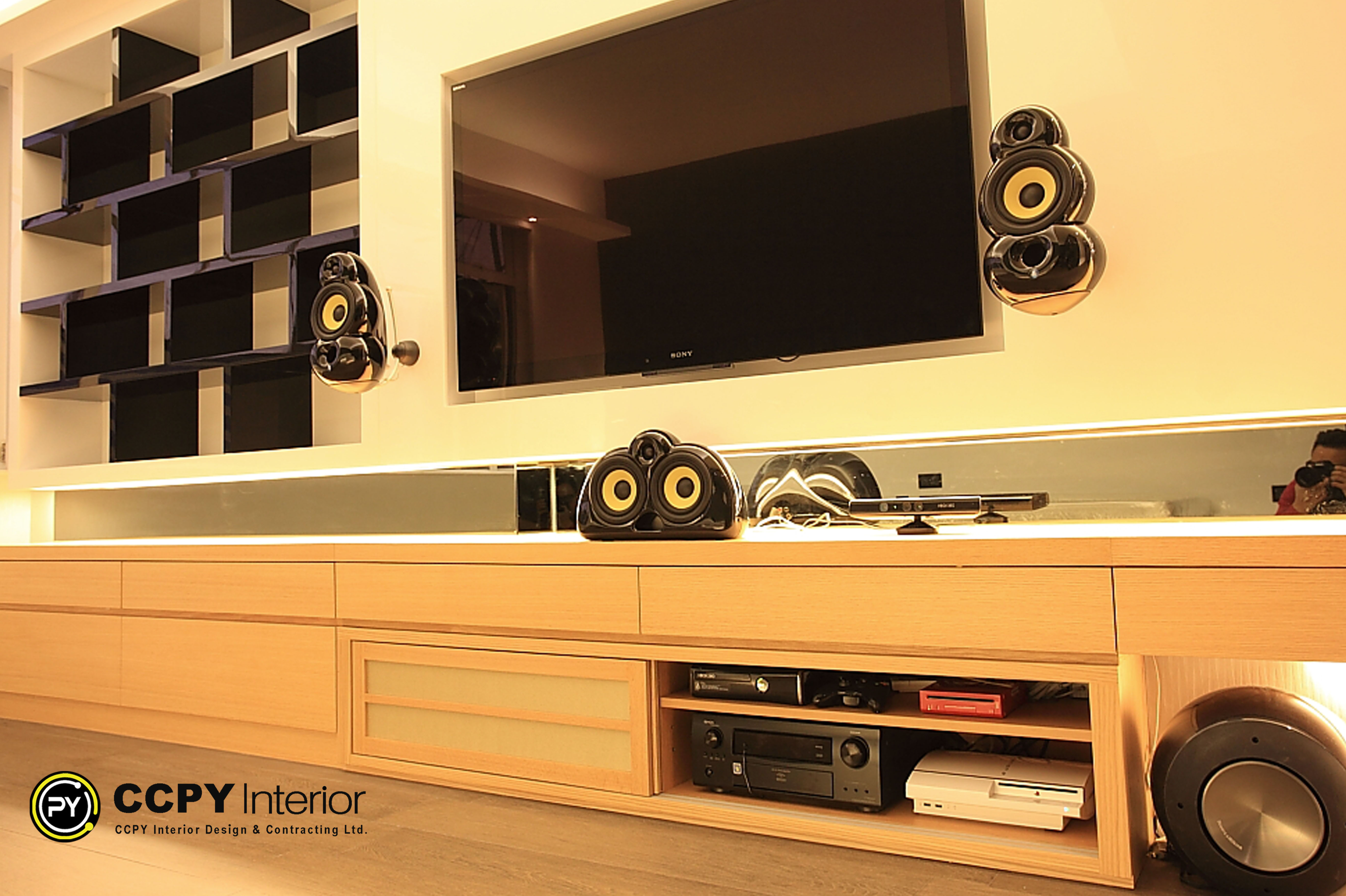 Detail of high-fidelity AV system at Standalone House, Perkins Road featuring B&W audio components, natural wood cabinetry, and recessed architectural lighting for a luxury mansion aesthetic.