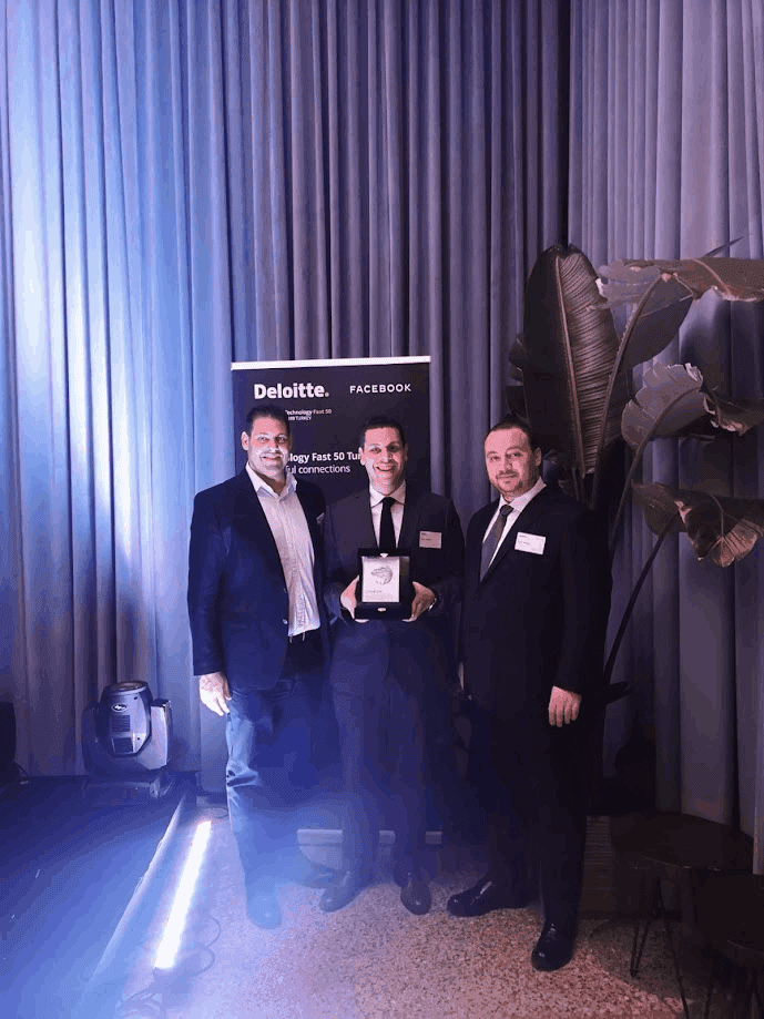 3 inveon executives at an event showing their new award