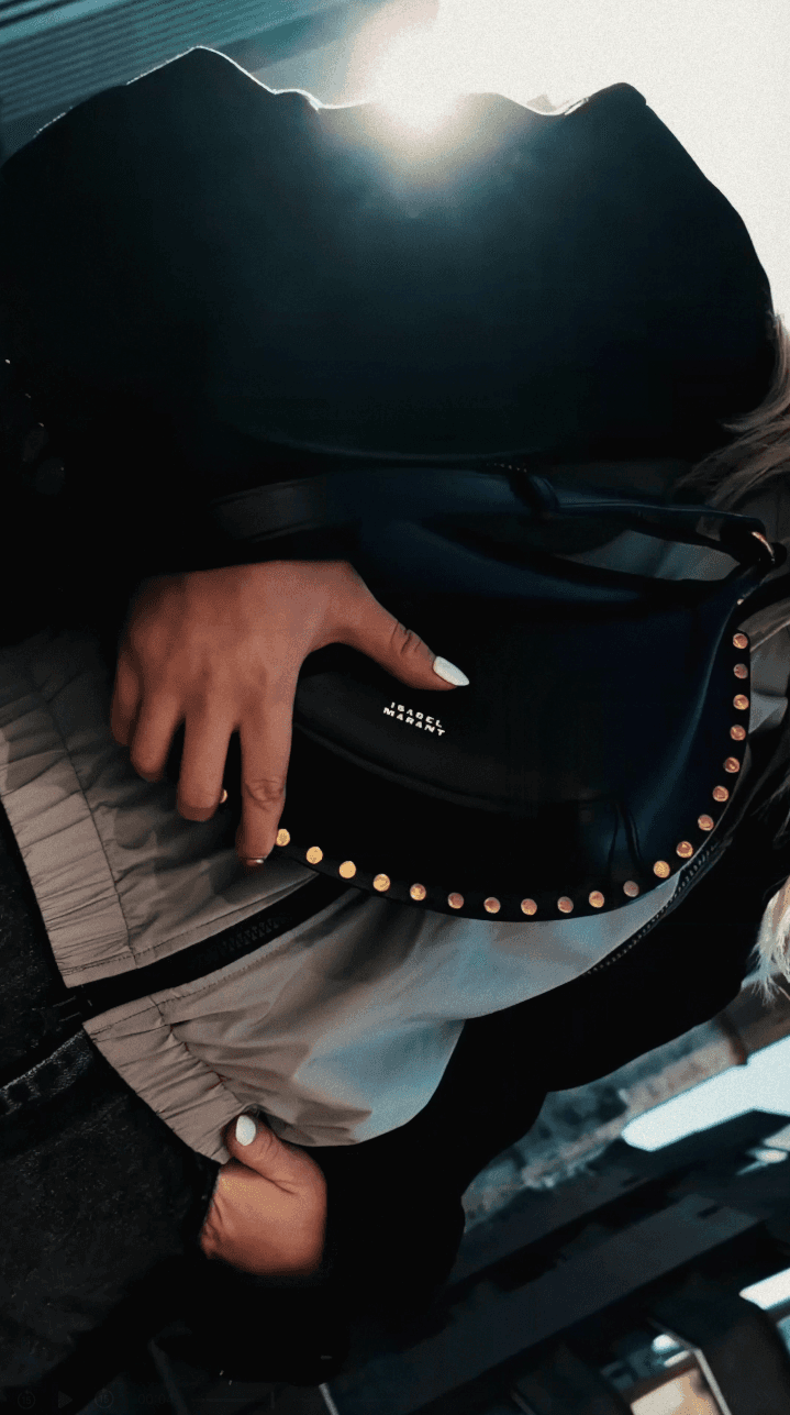 Tree branches against white house and fence