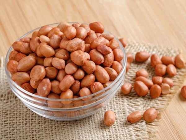 a transparent bowl full of peanuts