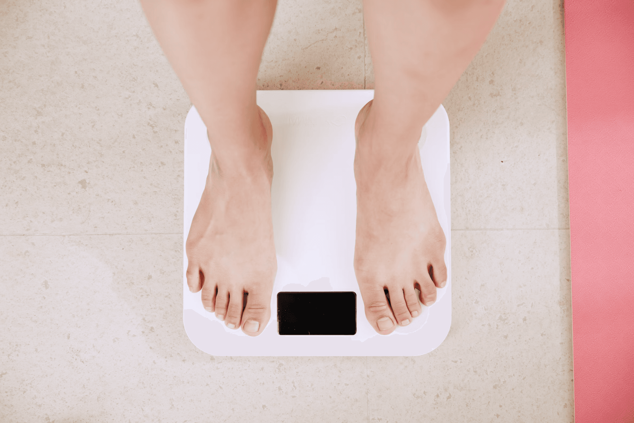 A Picture of Someone Placing their Feet on a Weighing Scale