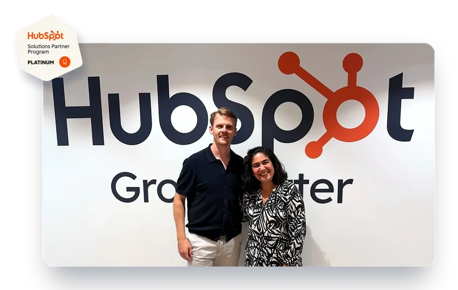 Will Andrew and Claudia Cadete at HubSpot’s office, with the HubSpot Platinum Solutions Partner badge